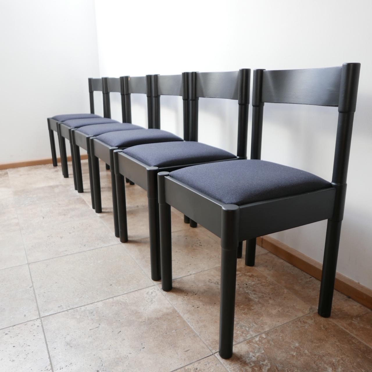 A set of six black dining chairs by Vico Magistretti. 

Italy, circa 1960s. 

Painted black, perhaps at a later date. 

Upholstered in a muted grey fabric, which could easily be replaced by our upholsterer's or one locally. 

Some scuffs and