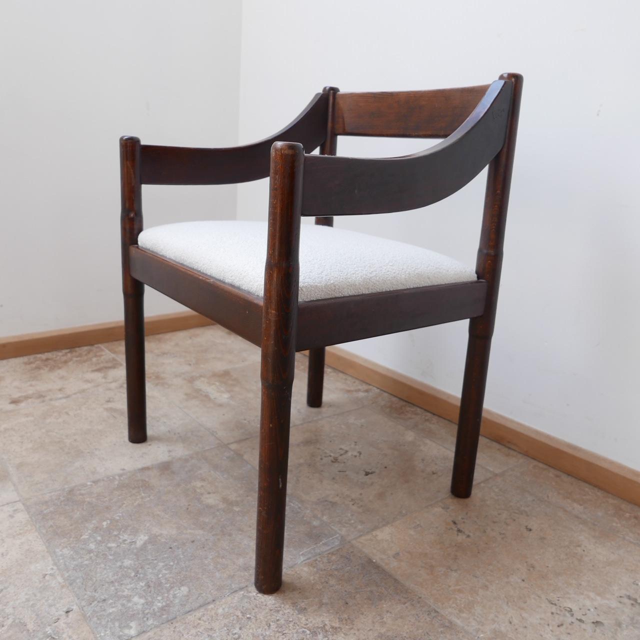An Italian armchair by Vico Magistretti. 

'Carimate' model. 

Italy, c1960s. 

Stained wood, re-upholstered with a new boucle from Chase Erwin Textiles. 

Stylish occasional chairs or dining chairs. 

Dimensions: 58 W x 52 D x 46 seat