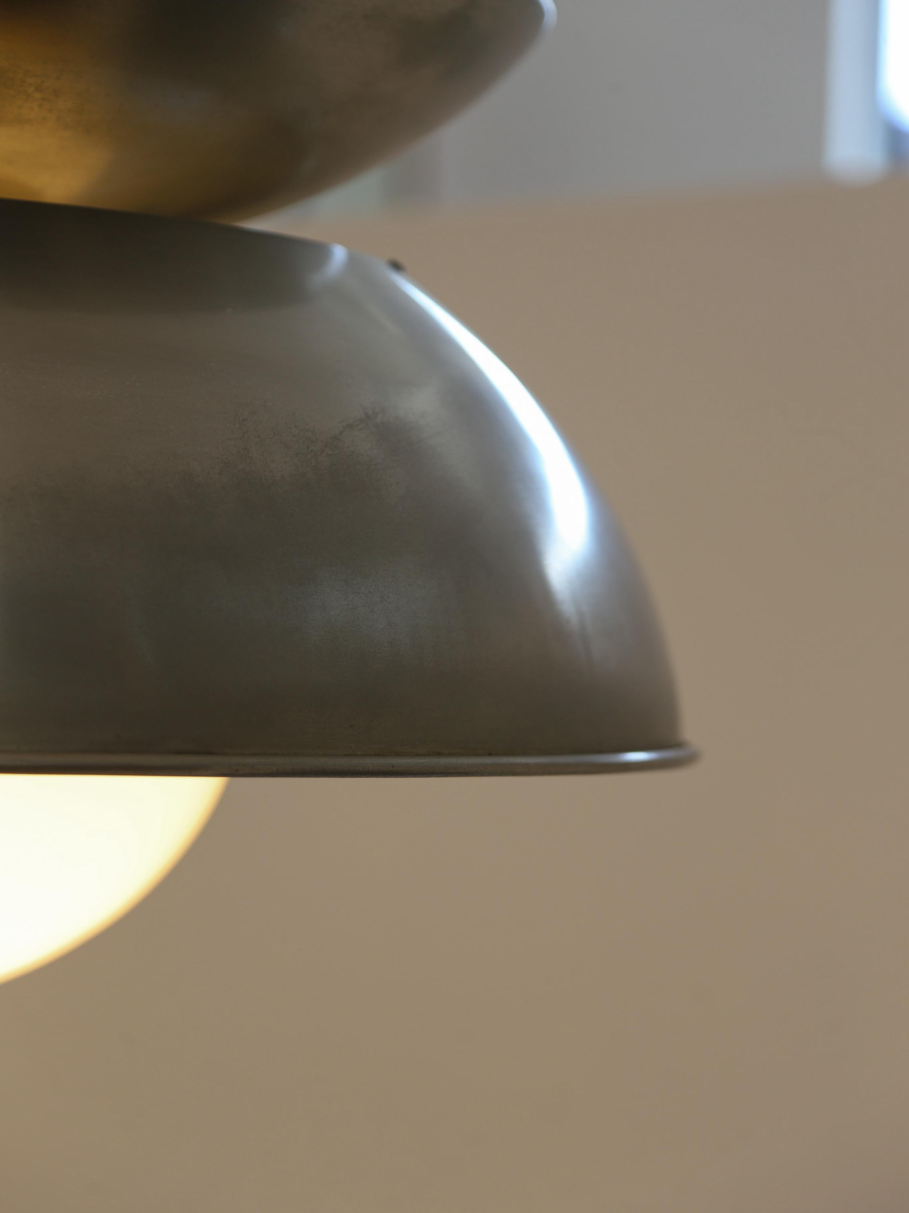 Add a touch of iconic Italian design to your space with this stunning Vico Magistretti pendant lamp for Artemide. Featuring a sculptural metal shade with an elegant patina finish, this mid-century modern masterpiece creates a warm, ambient glow with