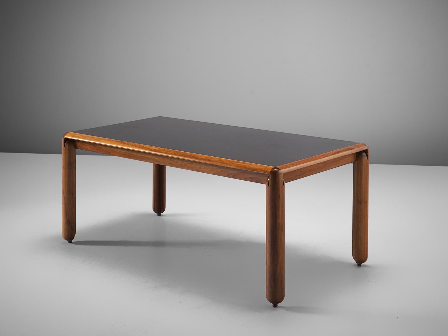 Vico Magistretti for Cassina, dining table, walnut and black lacquered wood, Italy, circa 1967.

Well detailed dining table designed by Vico Magistretti. The table features cylindrical legs and small bull point feet, which creates the illusions