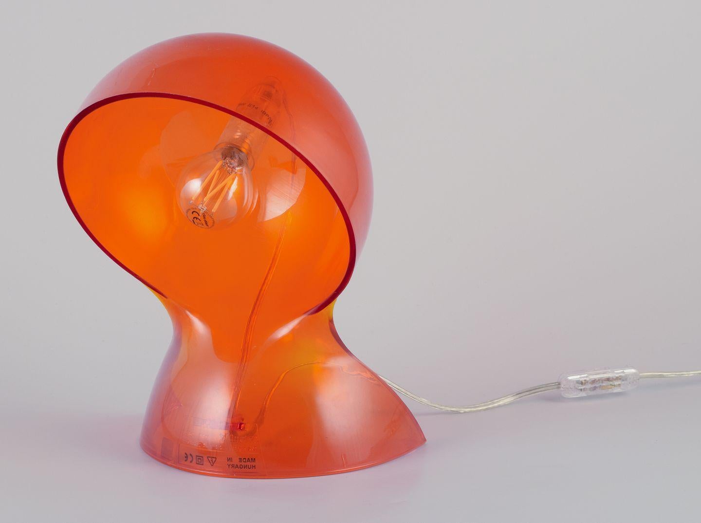 Pre-owned goods are exempt from import duties for U.S. customers. 
Therefore, no import tariffs will be applicable to your purchase.

Vico Magistretti for Artemide.
'Dalu' table lamp in translucent orange thermoplastic.
Designed by Italian designer