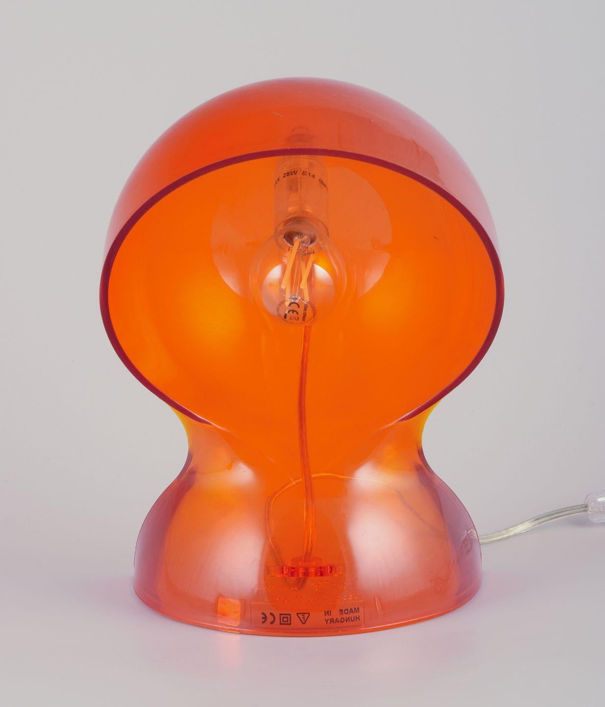 Italian Vico Magistretti for Artemide. 'Dalu' table lamp in translucent orange plastic. For Sale