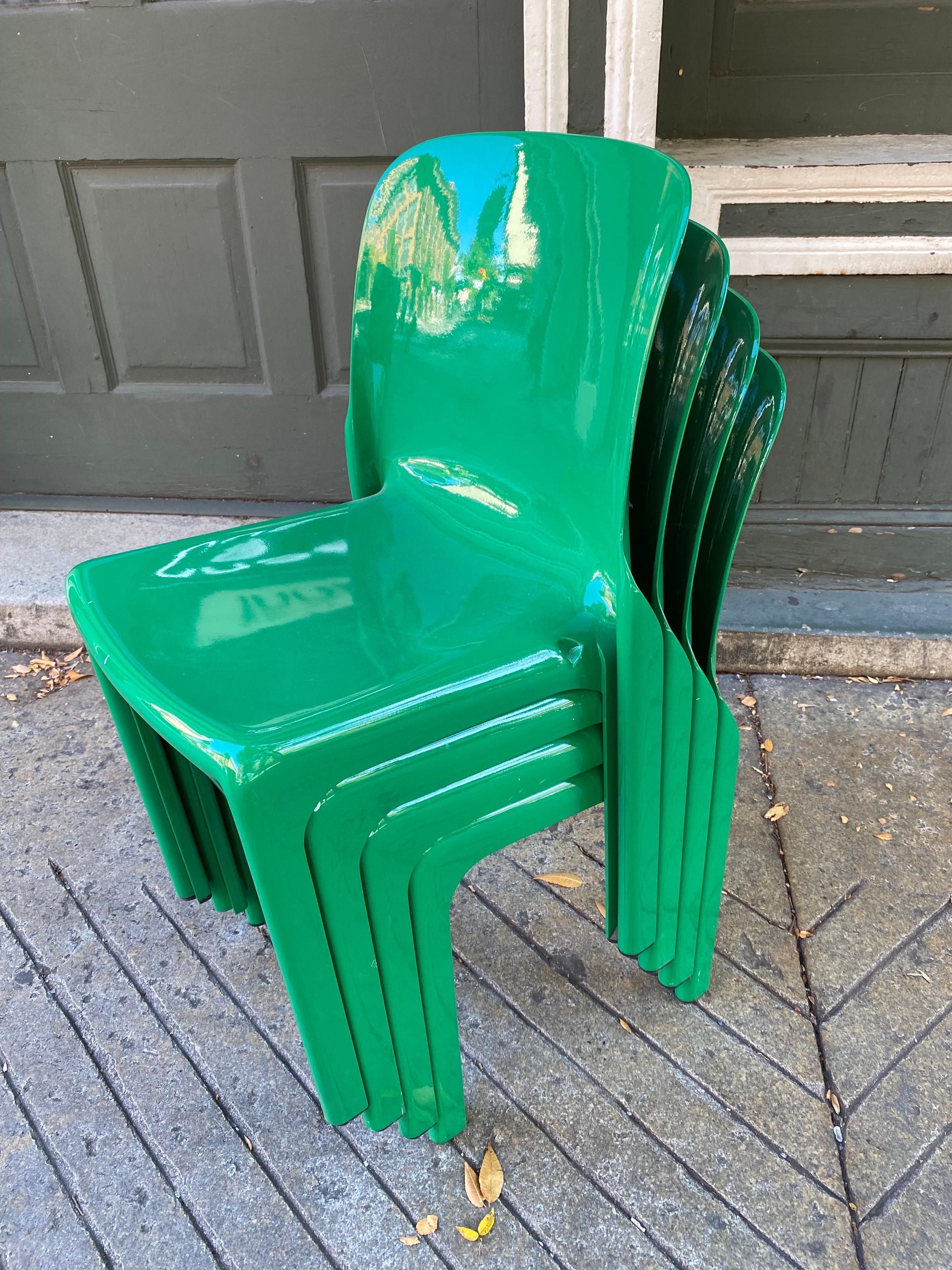Vico Magistretti set of 4 selene stacking chairs produced by Artemide. In very nice condition, with just a couple chips to finish as seen in photo. When not in use, chairs stack easily!