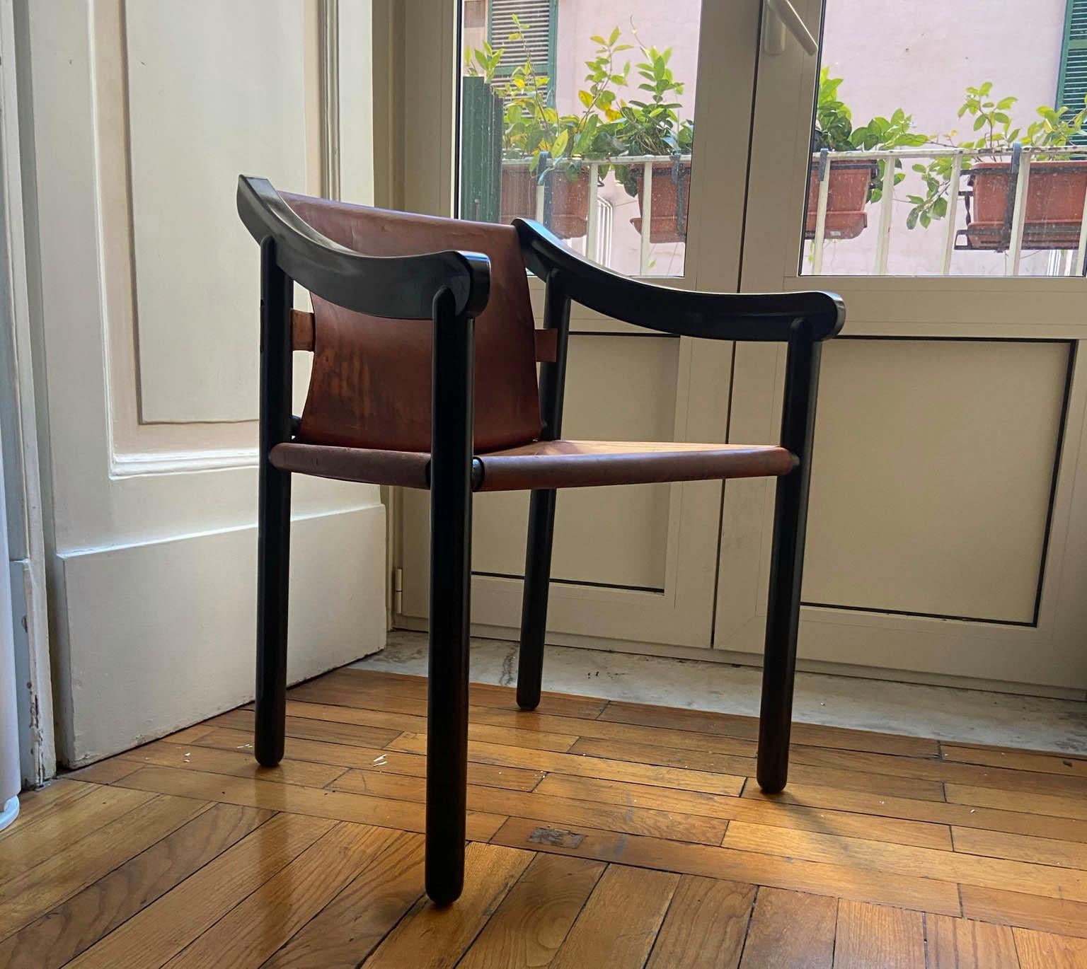 Vico Magistretti for Cassina, '905' armchair, black lacquered wood and leather, Italy, design, 1960s.

The elegant of the frame features cylindrical legs and curved arms. The design stands out due the self-supporting seat, made from one piece of