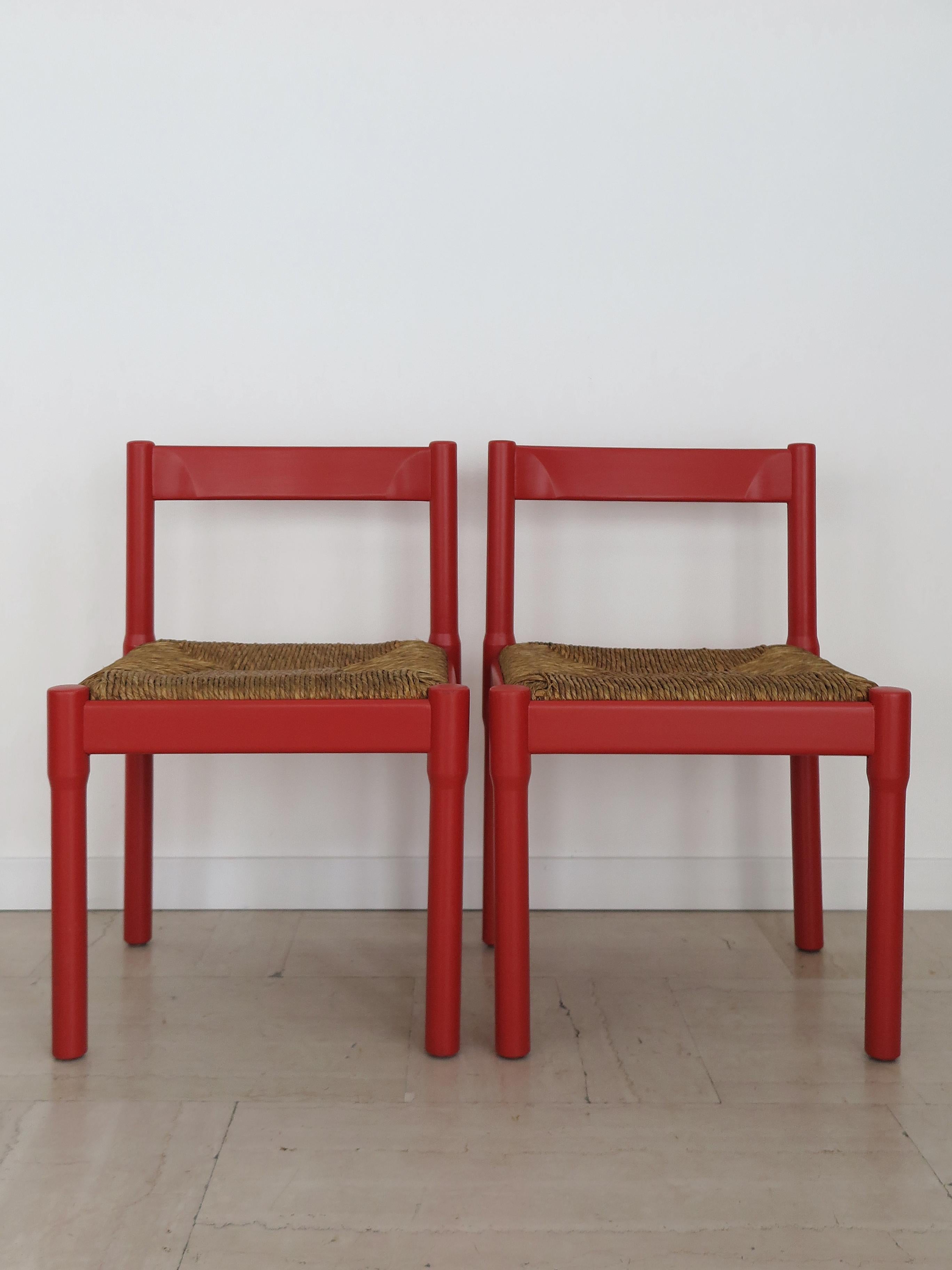 Italian midcentury modern design set of four dining chairs model Carimate designed by Vico Magistretti and produced by Cassina from 1960s with an analine-stained beech wood frame and straw seat, designed for the Carimate Country Club, from which