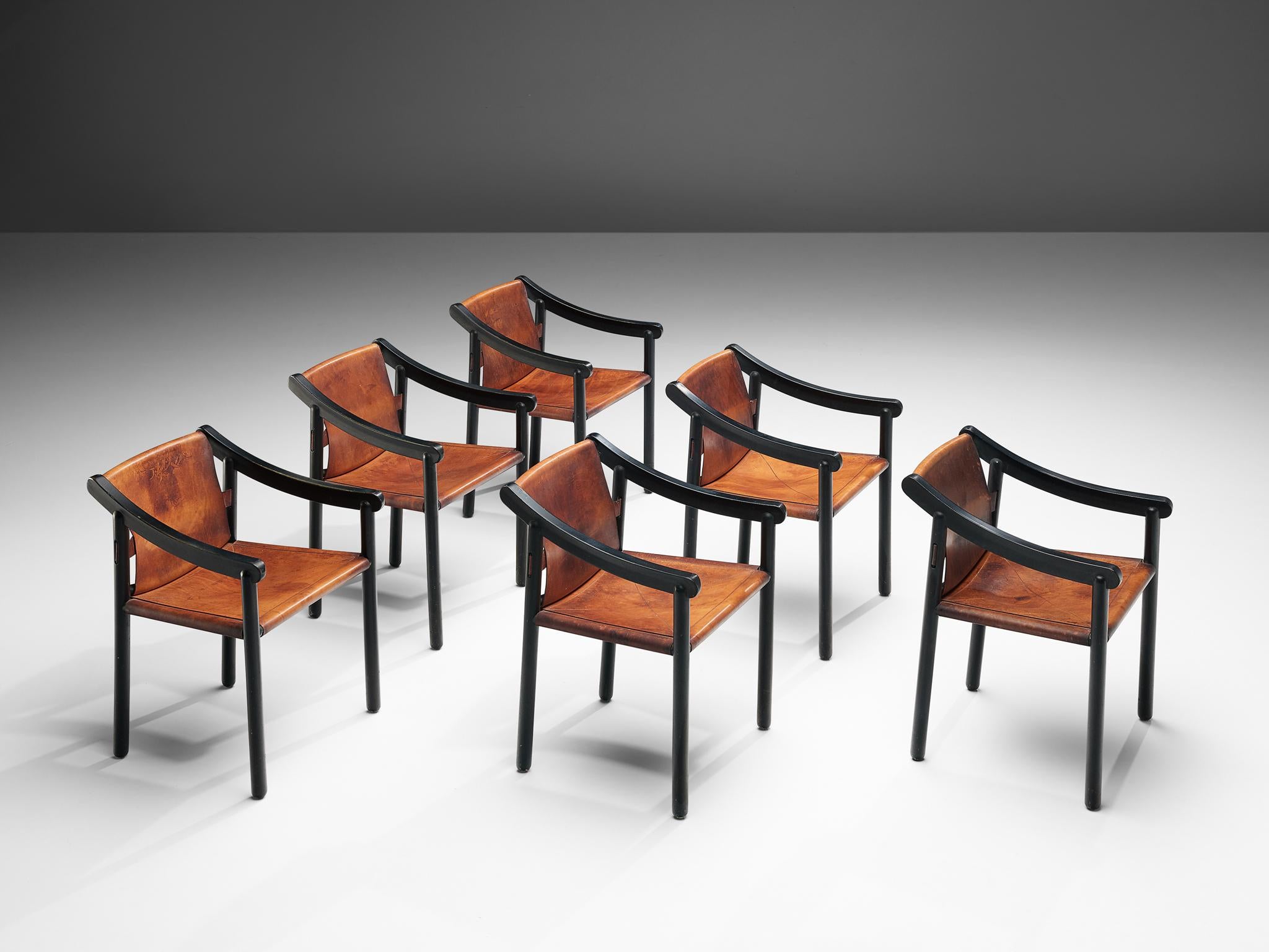 Vico Magistretti for Cassina, set of six '905' armchairs, black lacquered wood and cognac leather, Italy, 1964.

Designed by Vico Magistretti and produced by Cassina, this set of chairs features the original elements of this early '905' model. The