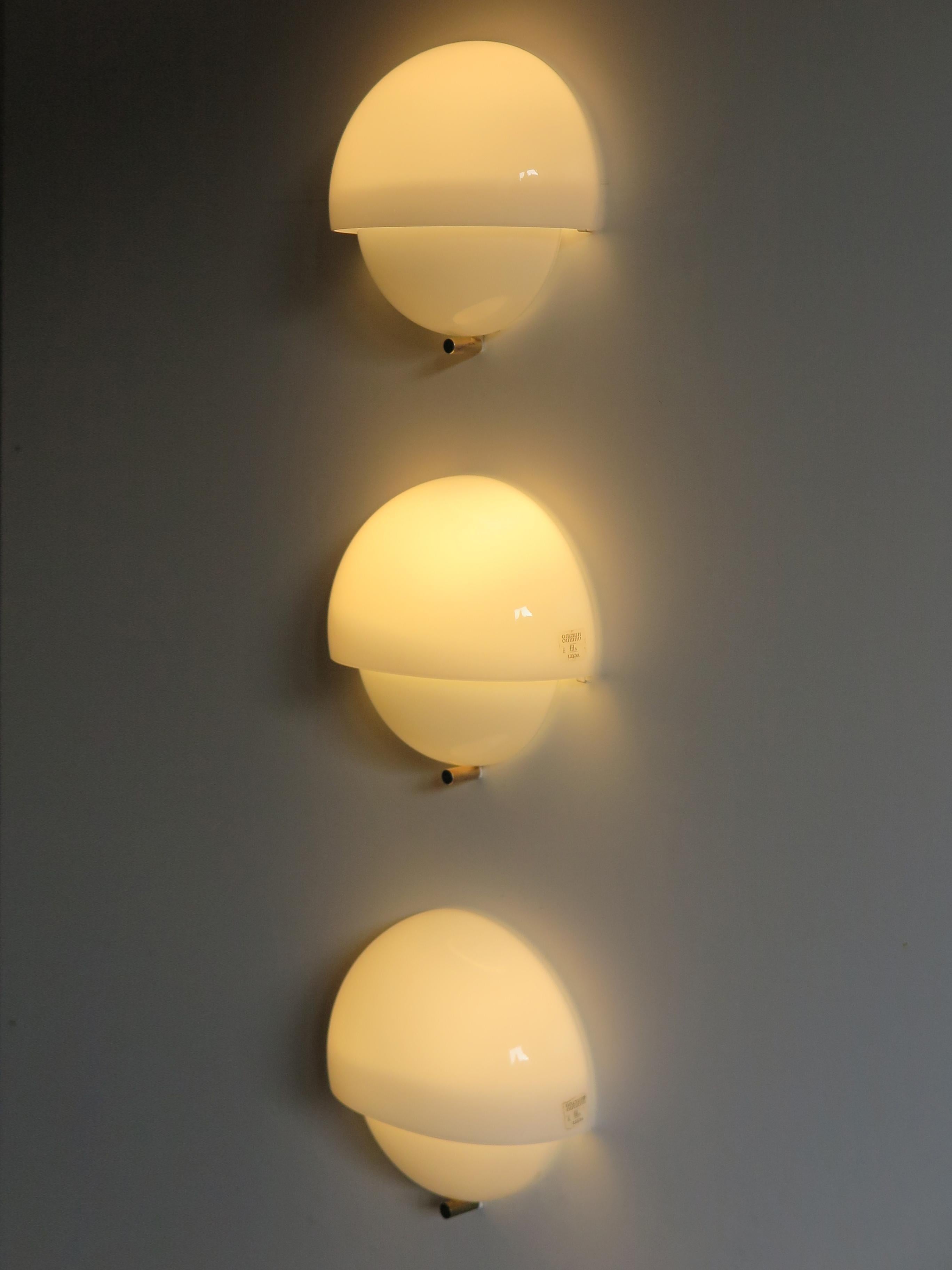 Set of three Italian sconces or wall lamps model Mania designed by italian designer Vico Magistretti for Artemide in 1963 with Murano white glasses, 1960s 
XIII Triennale.
Excellent vintage condition.
