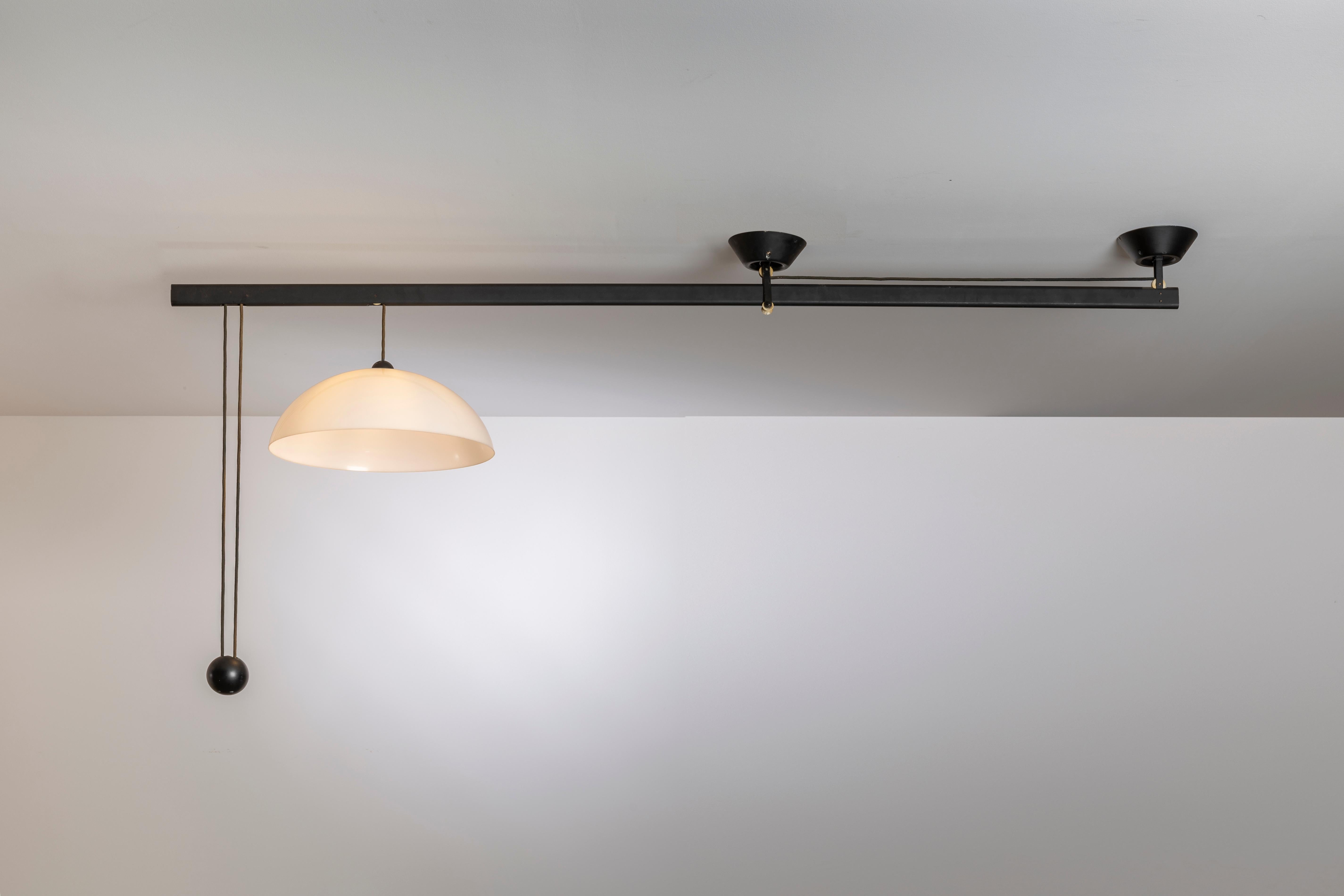 The L’Impiccato ceiling lamp, designed by Vico Magistretti in 1972 for Artemide, is a masterful synthesis of geometry, balance, and function — an example of how Magistretti transformed rational design into a poetic gesture. The piece is composed of