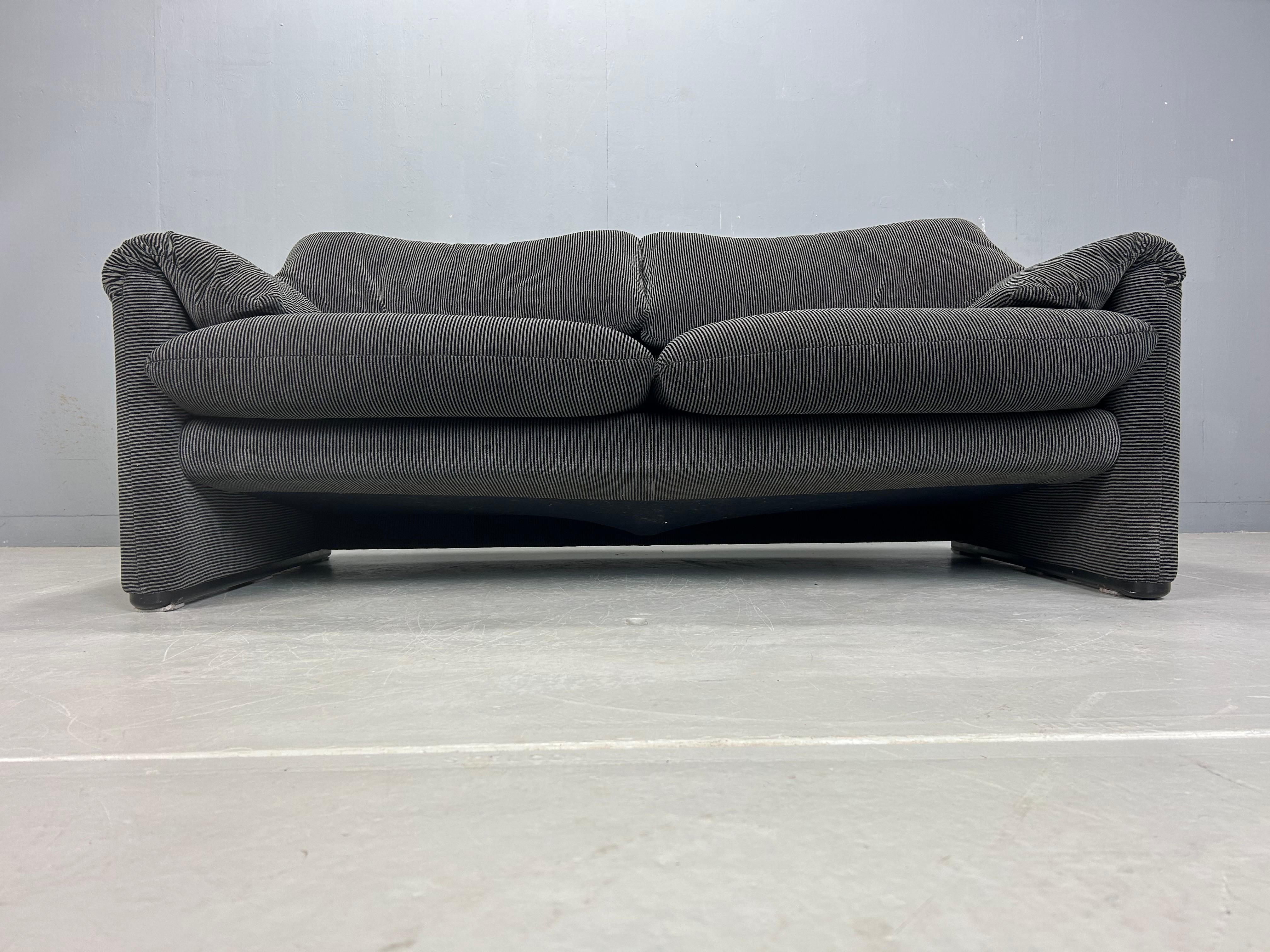 If it's classic Italian style you're after, look no further!

Maralunga 2 -seat Sofa, designed 1973 by Vico Magistretti for Cassina. This sofa features folding back rests cushions that can be folded down, or folded up to provide the user with more