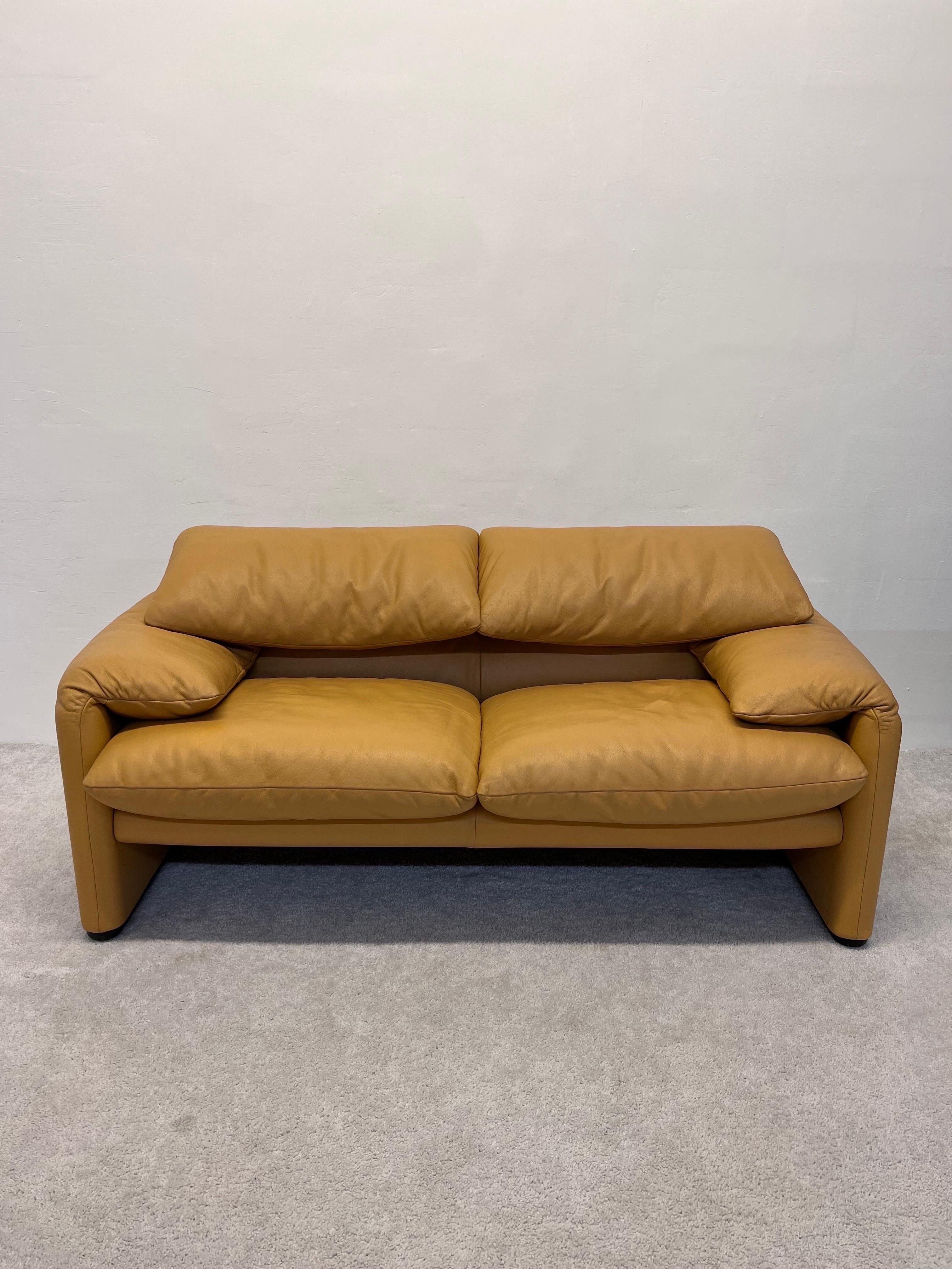 Maralunga two-seat sofa with the defining adjustable head rests designed by Vico Magistretti for Cassina. Original yellowish tan leather. The Maralunga was originally designed in the 1973 and this example was produced by Cassina circa 1980s.

See