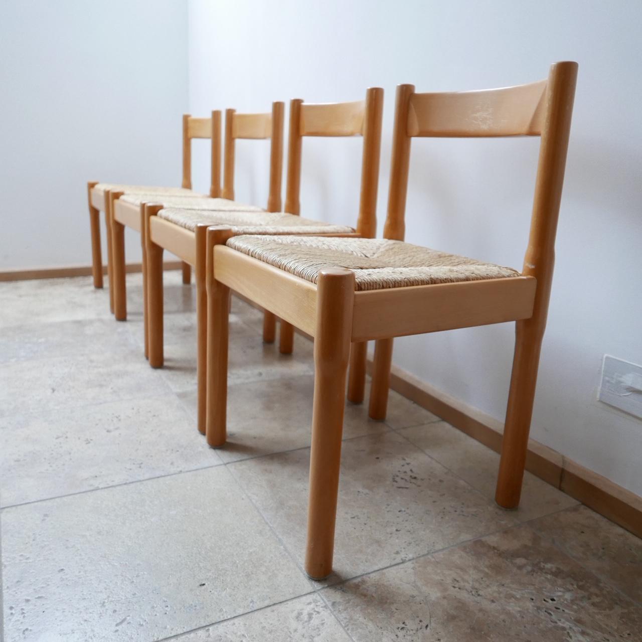 A set of dining chairs by Vico Magistretti.

'Carimate' Model.

Italy, circa 1960s.

Rush seats in perfect condition.

Some scuffs and wear consistent with age but generally in good condition.

Price is for the four.

Dimensions: 51 W x