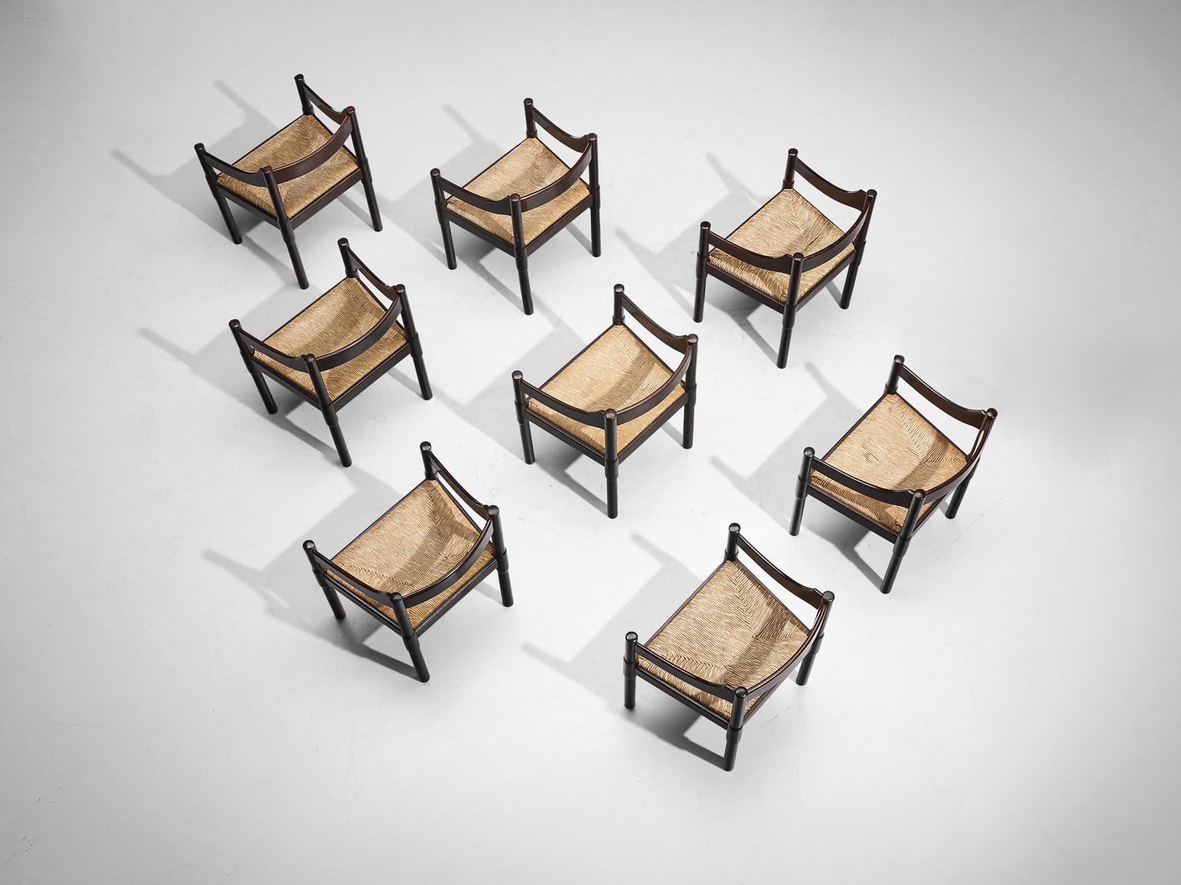 Vico Magistretti, ensemble de huit fauteuils 'Carimate', modèle '892', hêtre teinté, jonc, Italie, design 1963

La chaise 