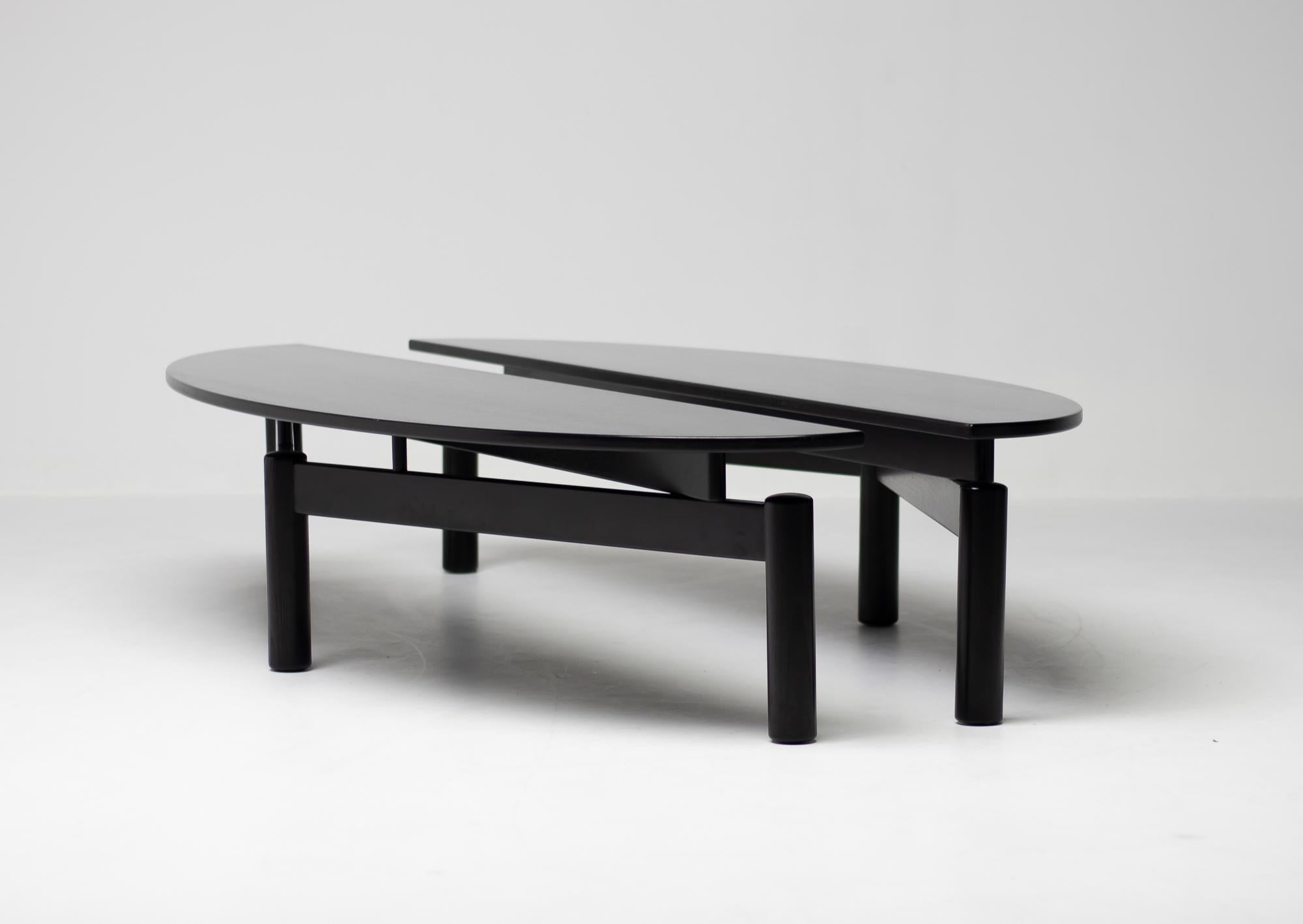 Pair of Sinbad tables designed in 1982 by Vico Magistretti for Cassina.
Black stained ash, marked with Cassina label.

Tables have demilune-shaped tops which can be configured in several interesting configurations.
They are substantial enough to