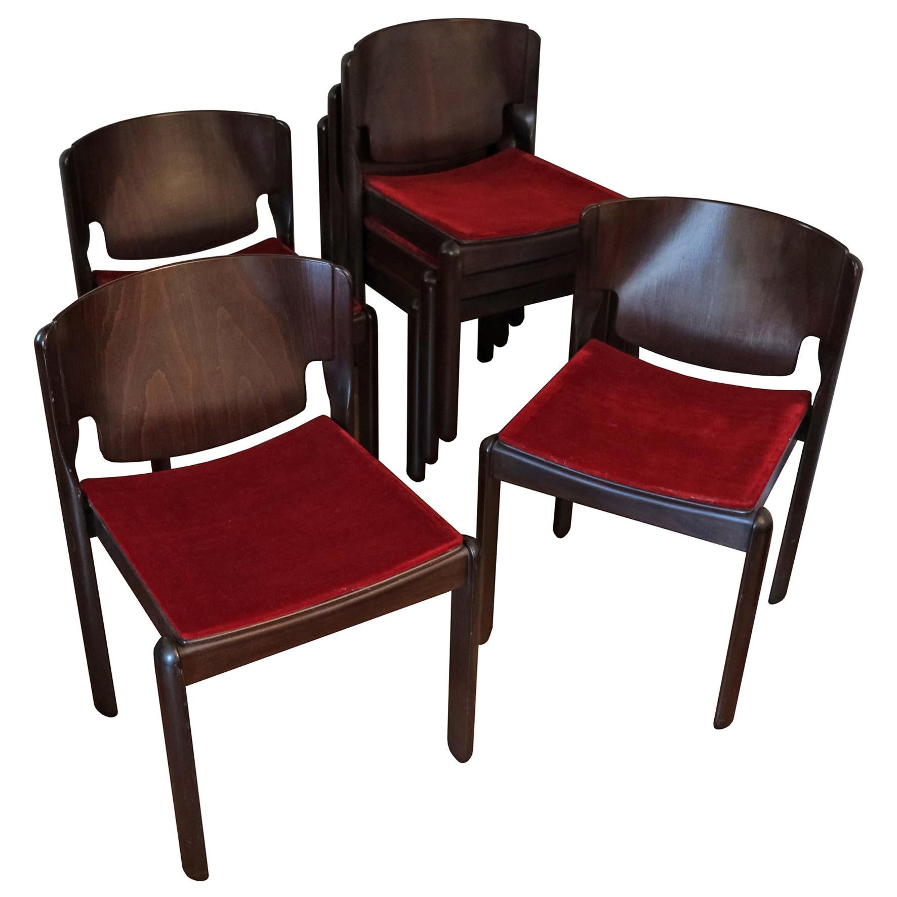 A set of six dark brown walnut stackable dining chairs. Each with a bent plywood back, the seat upholstered with burgundy velvet on four feet.
Manufactured by Cassina.
Italy.
1967.

Provenance
Private collection

Literature
Domus 444,