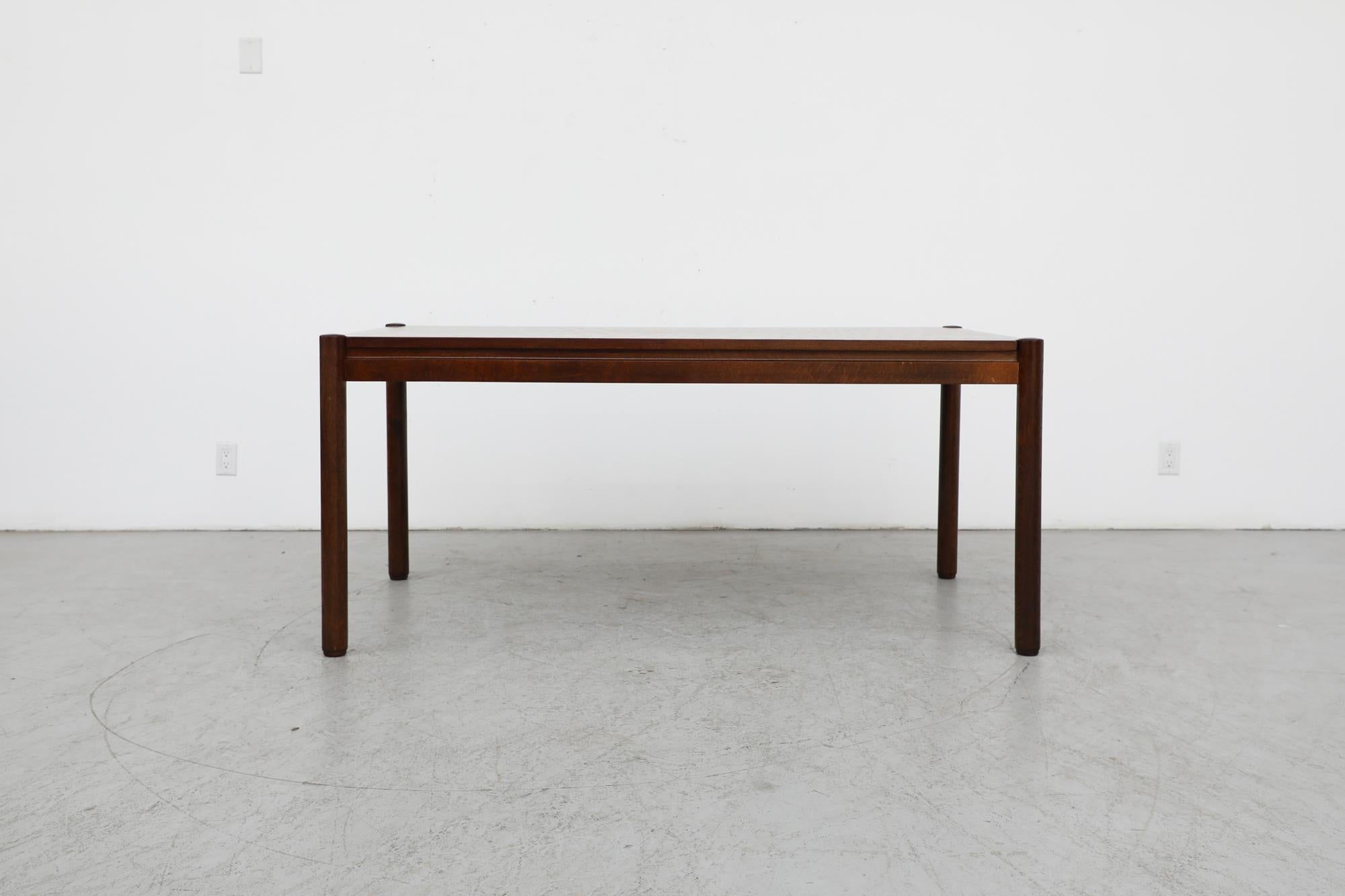 Mid-Century Vico Magistretti inspired dark oak dining table with a classic design. The table is in original condition with visible wear, including scratches. Wear is consistent with its age and use.