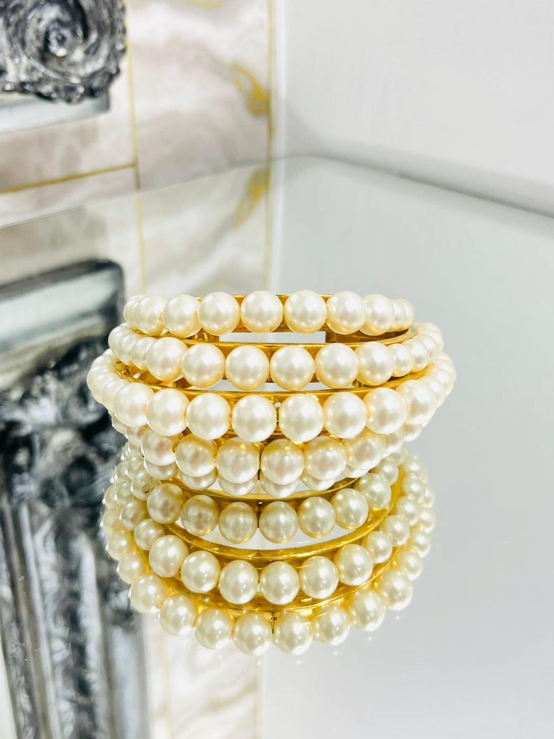 Victoire de Castellane for Chanel Multi Tier Cuff

Rare five row faux pearl cuff set in heavy gold plated open 

cuff bracelet. From 1984 collection.

Size - One Size 

Condition - Vintage - Very Good

Composition - Gold Plating, Metal, Fux