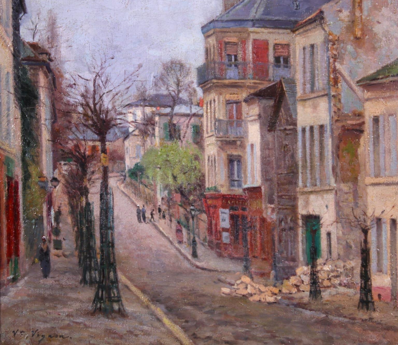 A charming oil on canvas circa 1880 by French Impressionist painter Victor Alfred Paul Vignon depicting figures on a street in Montmartre on what looks to be a cool day. To the right there is a pile of rubble from a demolished building.