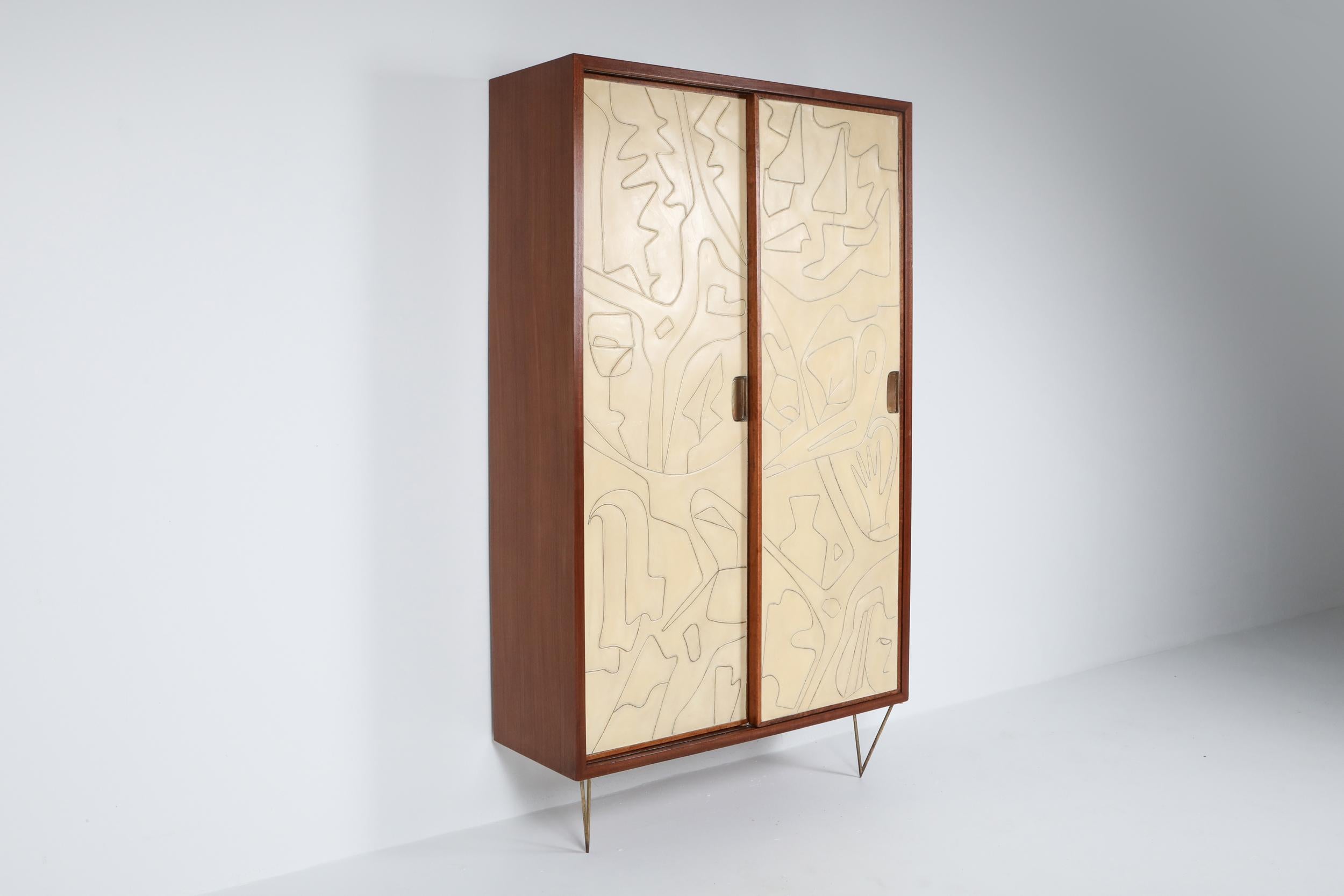 Victor Cerrato, cabinet, wood and brass, Italy, circa 1958.

This masterpiece is pure art, amongst our favorite pieces as of yet.
The dresser has a solid mahogany frame, beech interior and is mounted on brass harpin legs. The two door panels are
