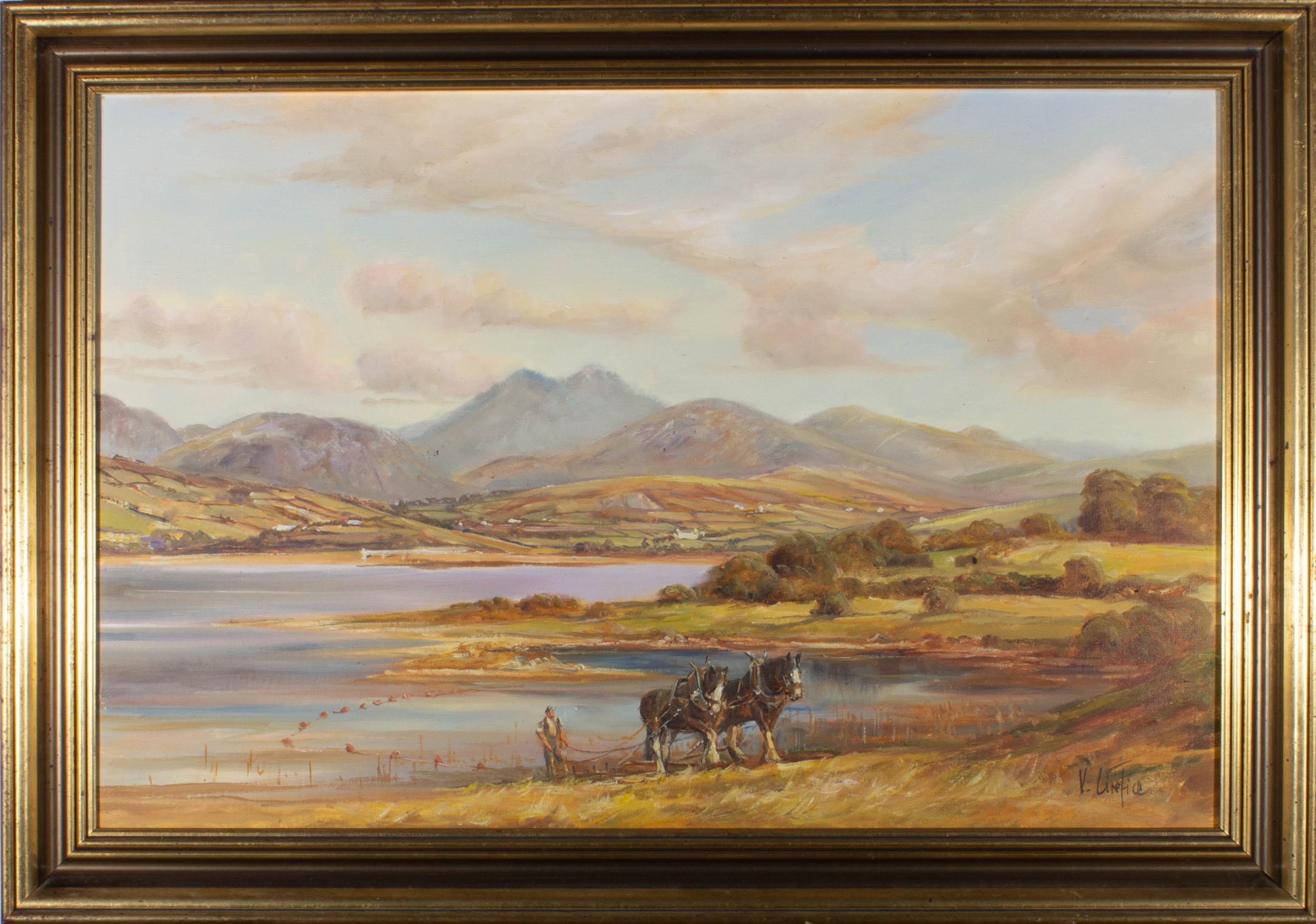 Depicting two plough horses working the field against a vast background of scenic mountains and lakes. Painted in a warm palette, the artist has used stunning detail to capture the Mournes landscape in Northern Ireland. Signed to the lower right.