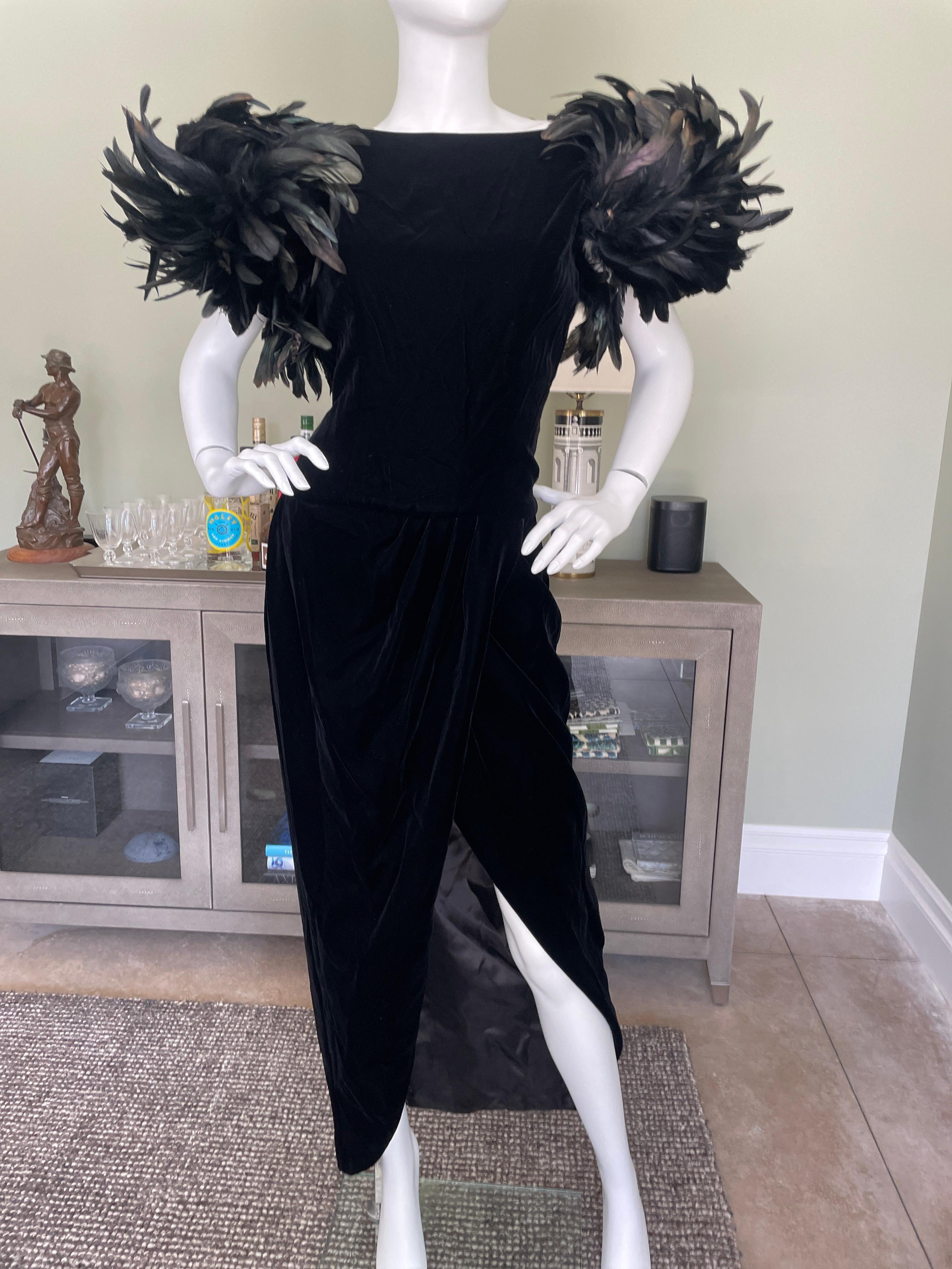 Victor Costa for Neiman Marcus Stunning 1980's Black Velvet Evening Dress with Exaggerated Coq Feather Shoulders.
This is sensational, a real entrance maker, with a high slit, and low cut back.
Size 8 
Bust 36