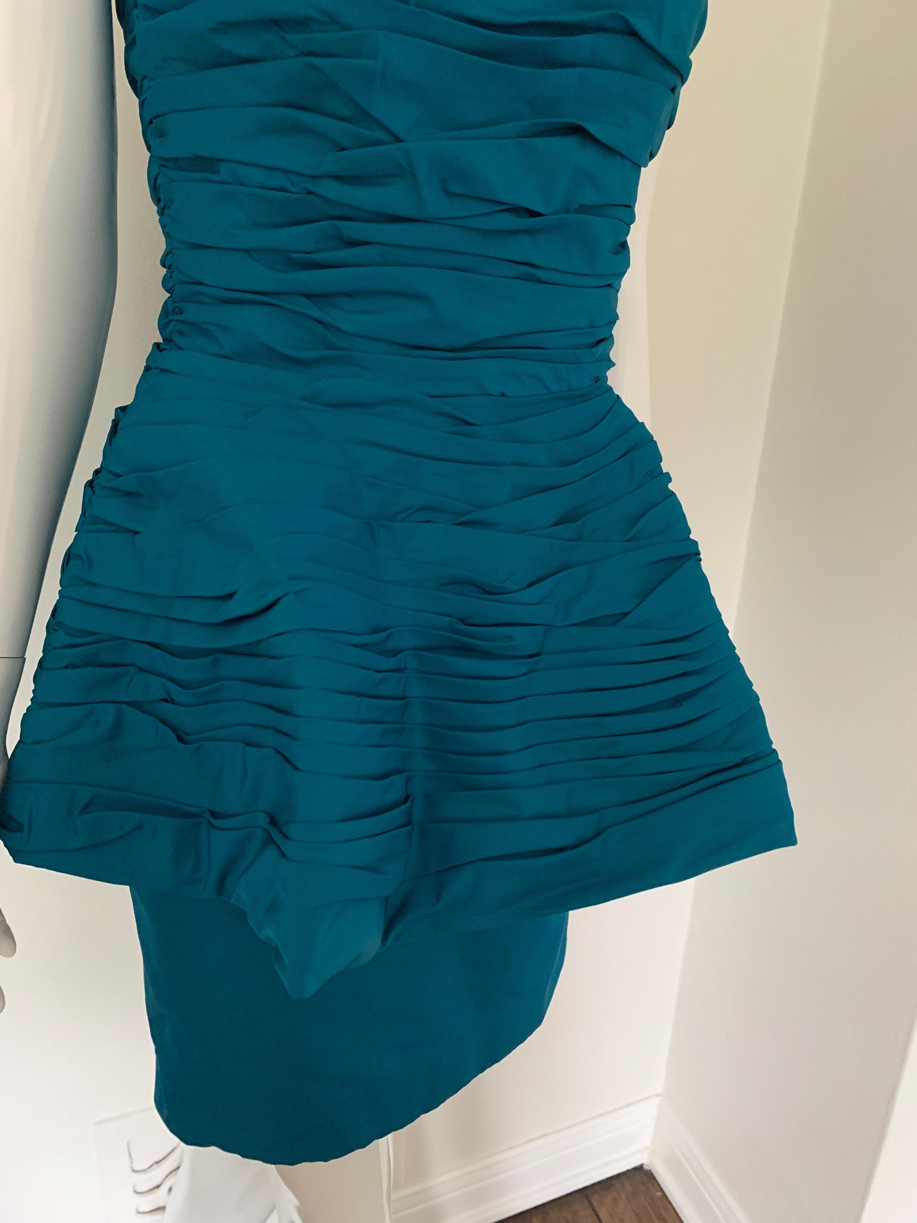The Ultimate Victor Costa 80s/90s party dress. 
Strapless with ruching, double-layered skirt. 
Knee-length, button, and zipper in the back. Teal in color, great condition for a vintage piece. No size listed - but appears to be a US size 0/2. 