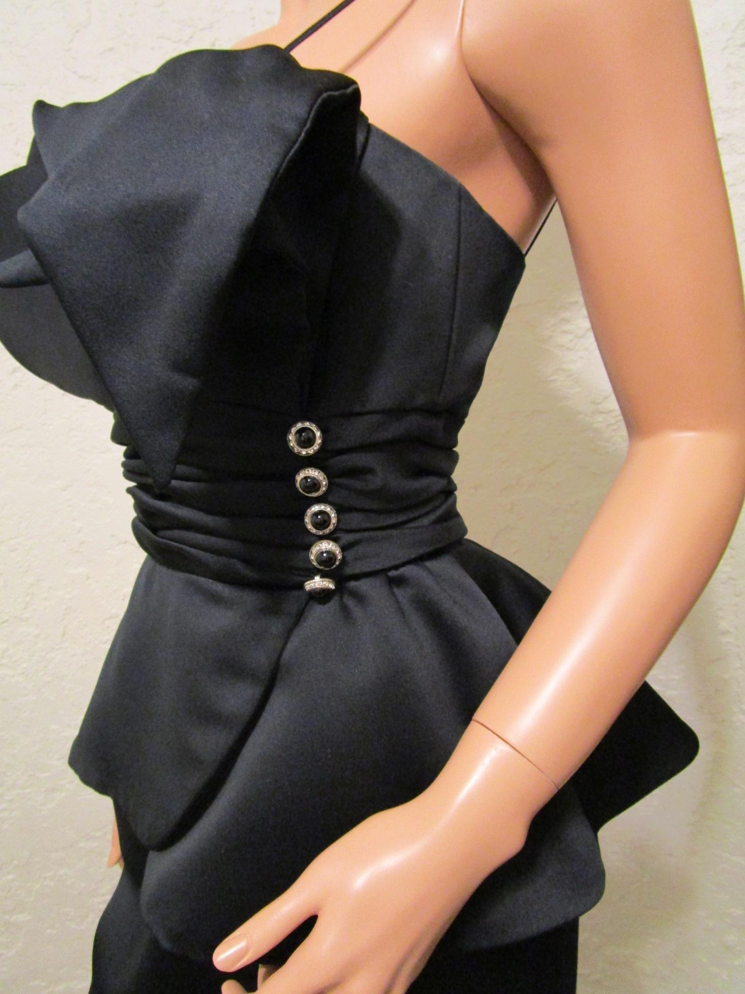 Gorgeous VICTOR COSTA cocktail evening dress in black satin with one spaghetti shoulder strap.   Bust design has interior wires for adjusting the perfect look.

Slim split skirt with ruching and flare waist detail accented by 5 decorative rhinestone