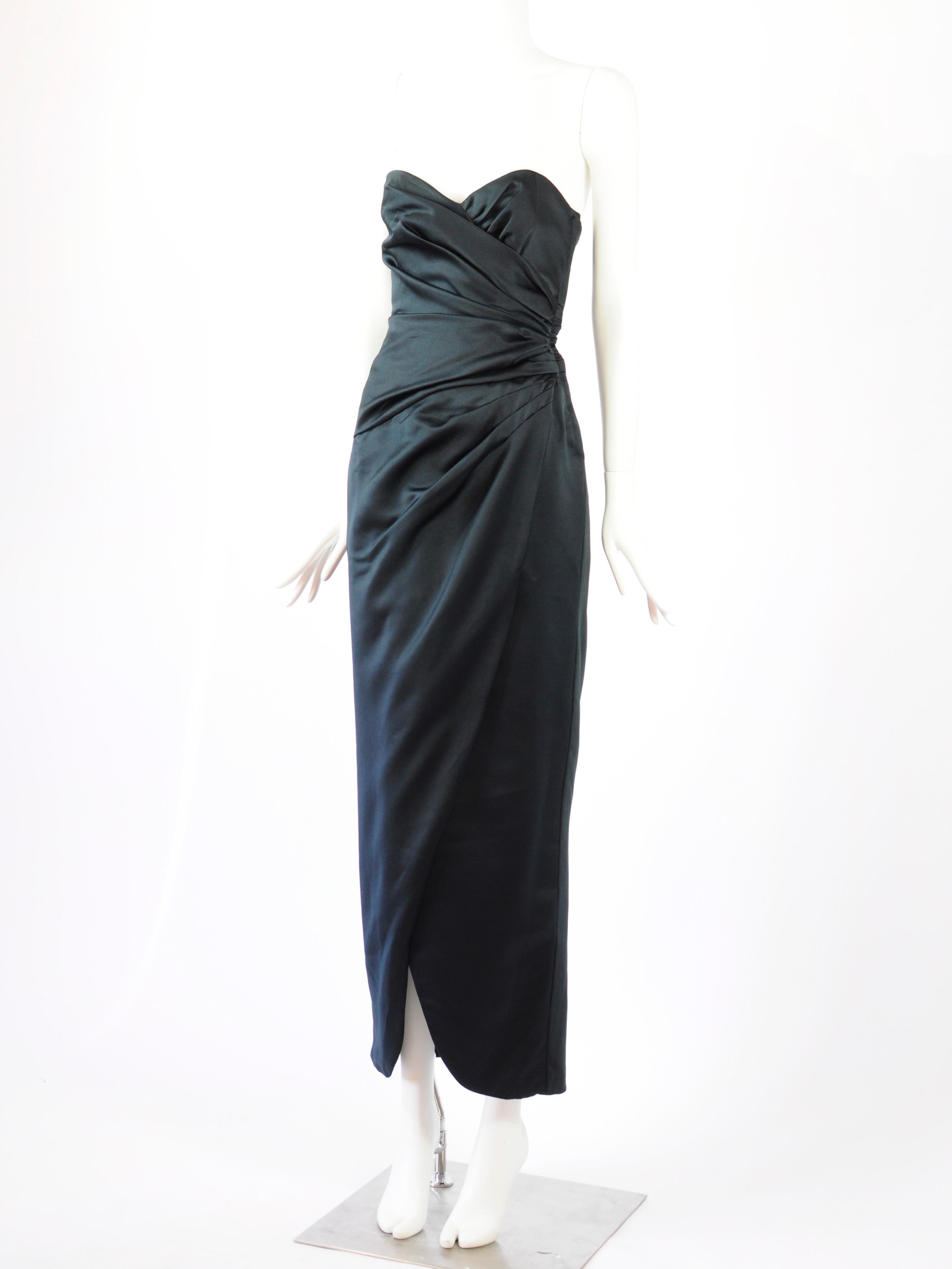 Victor Costa strapless dress in black structured, draped satin from the 1980s. Has a very old hollywood glamourous feel to it. The draping creates an overlap on the skirt which will allow for a cheeky slit effect on the front when moving. There is