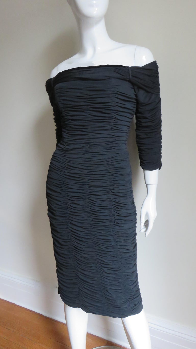A great black fine jersey dress from Victor Costa.  It is ruched horizontally front and back and cut to reveal the shoulders.   It has 3/4 length sleeves, boning in the bodice and a back zipper.  It is fully lined.
Fits sizes Small, Medium.

Bust 