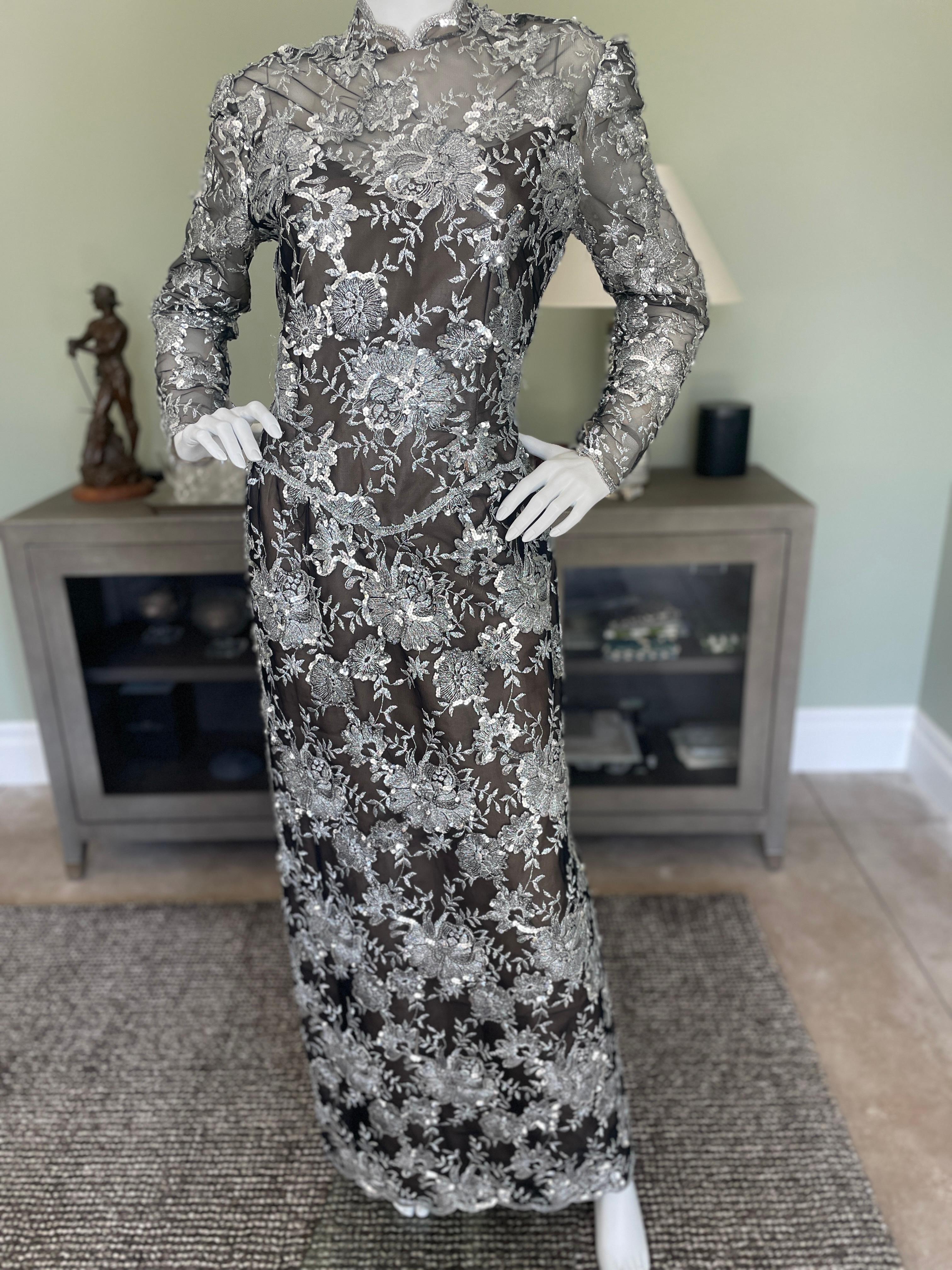 Victor Costa Vintage 1980's Embroidered Silver Lace Evening Dress 
This is sensational, a real entrance maker, with a high slit, and keyhole back.

Size 10
 Bust 40