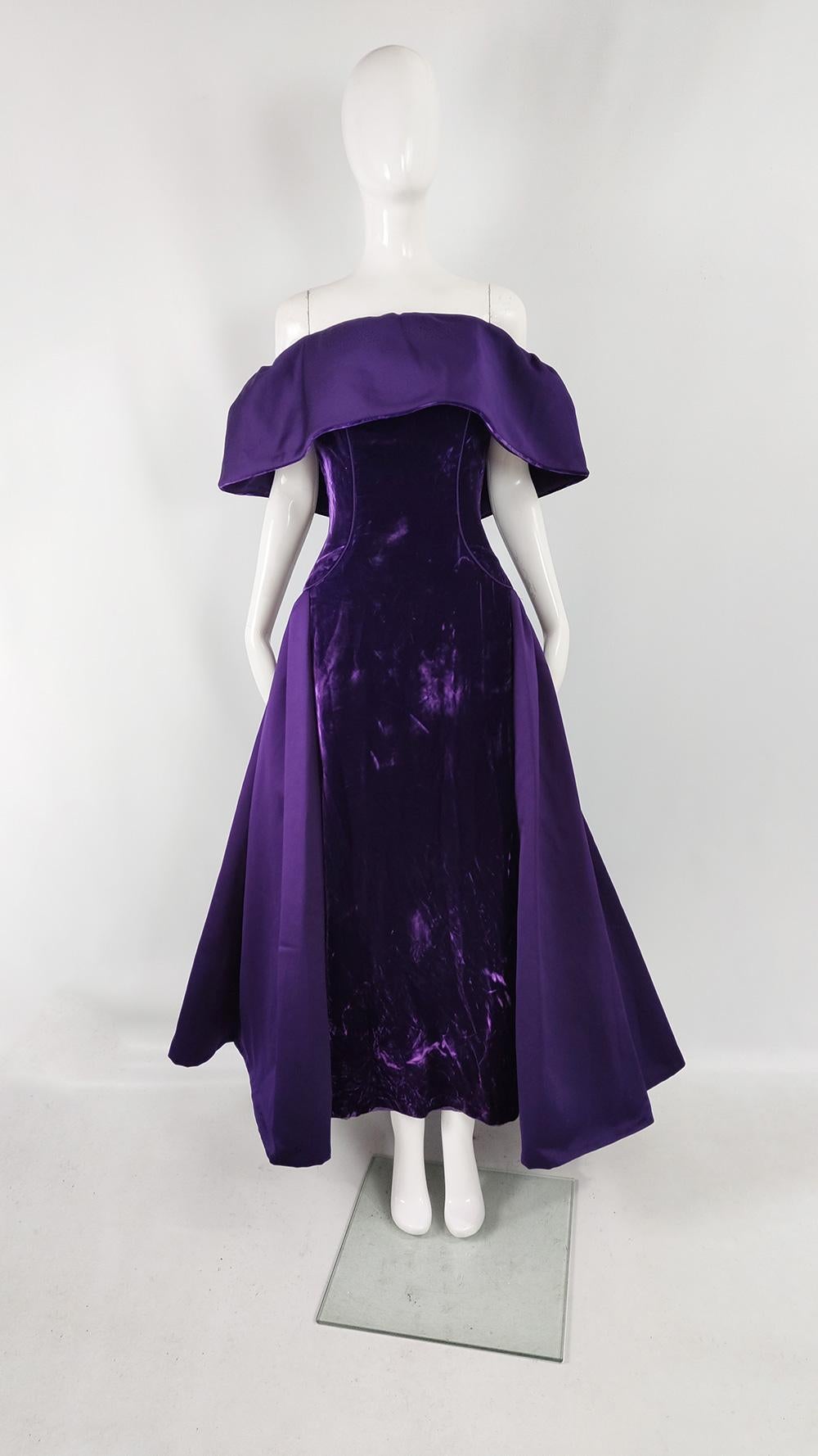 A breathtaking vintage womens evening ball gown from the 80s by luxury American fashion designer, Victor Costa. In a purple crushed velvet which has incredible lustre, with a dramatic off the shoulder shawl collar. It has an incredible full length