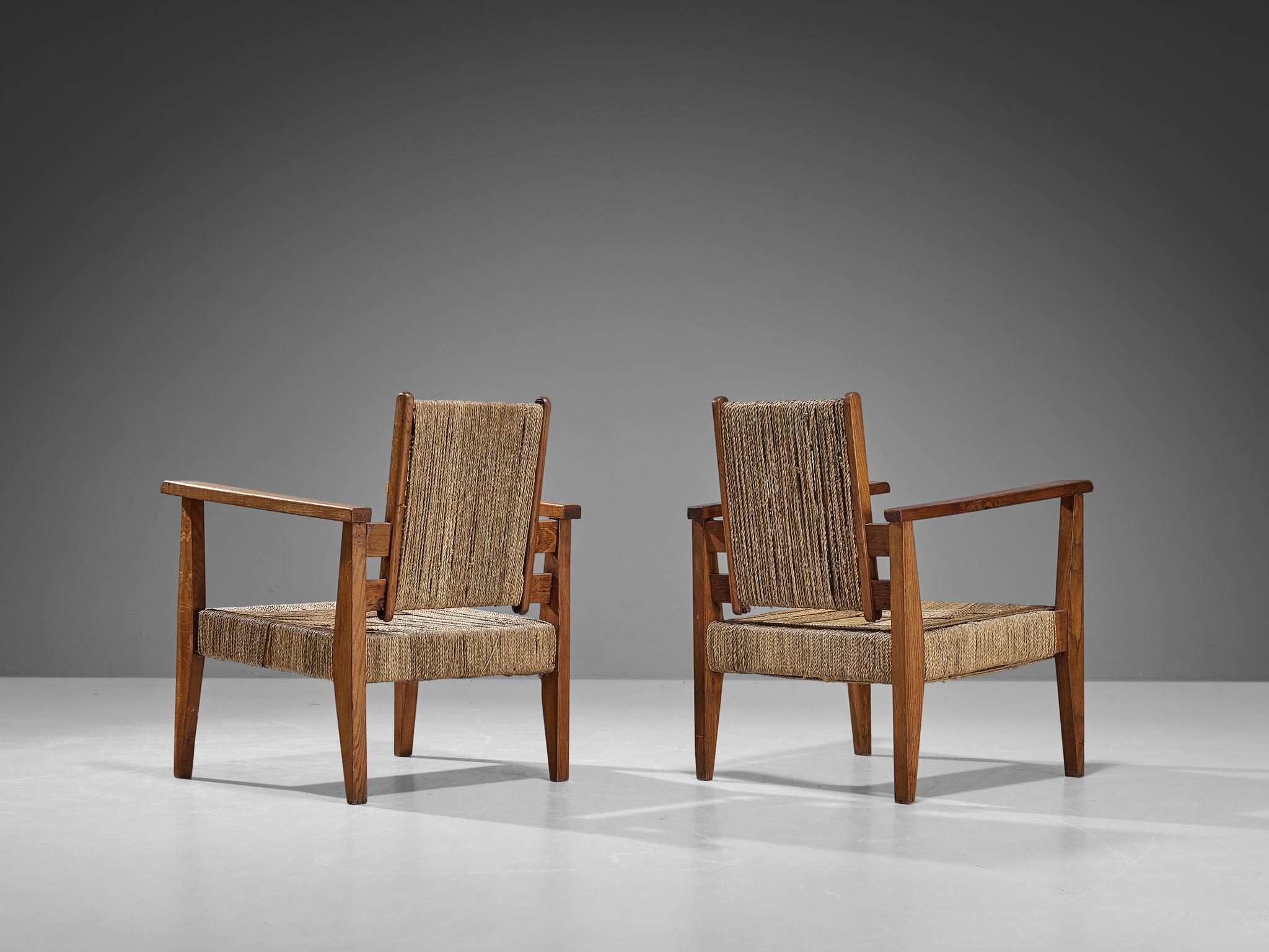 Mid-Century Modern Paire de fauteuils Victor Courtray en chêne et paille  en vente