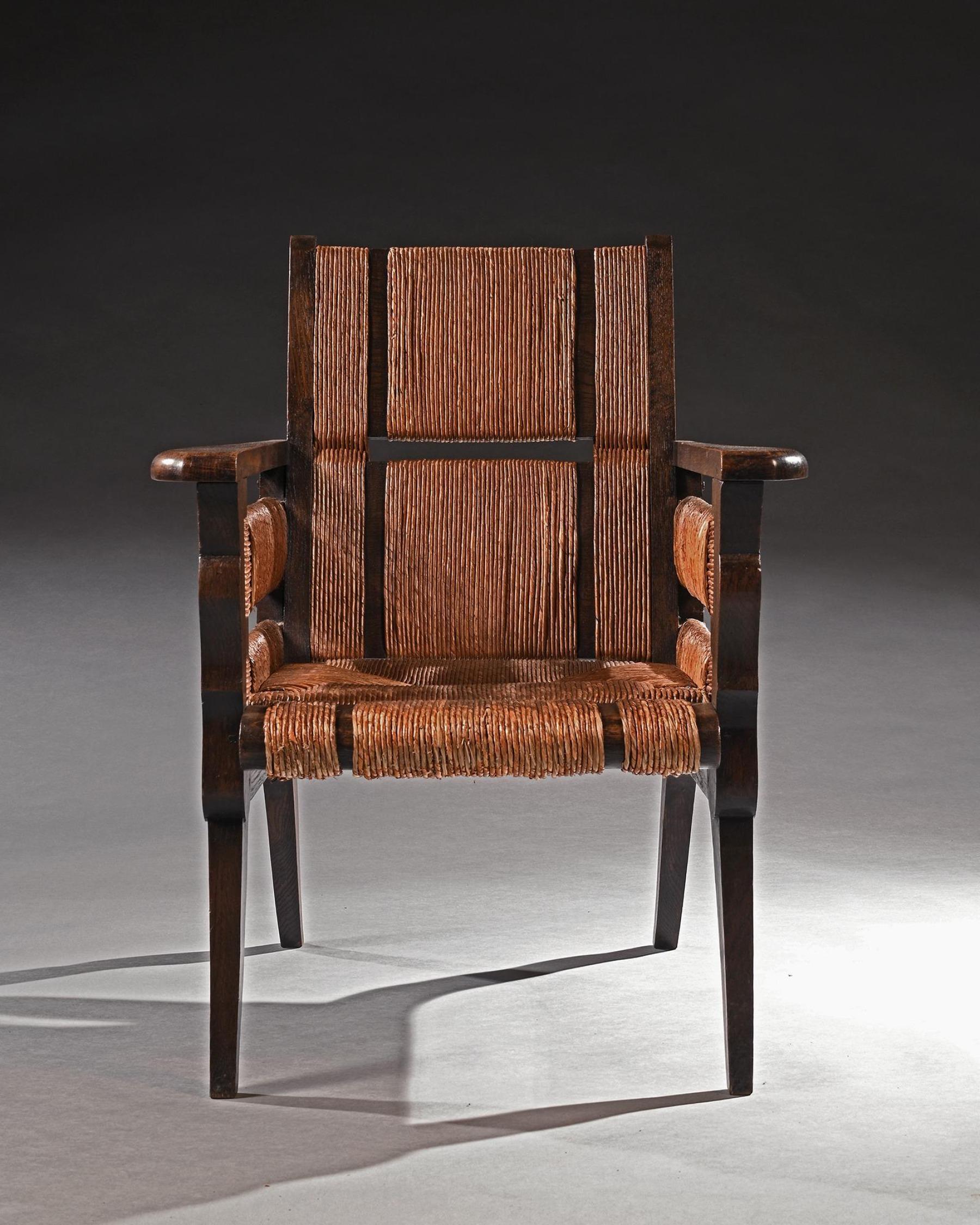 A wonderful and rare model Victor Courtray Mid Century Modern French oak and sisal armchair.
Victor Courtray (1896 - 1987)

French - 1940 

A very stylish and chic oak armchair with woven sisal sectioned back arms and seat raised on sabre front