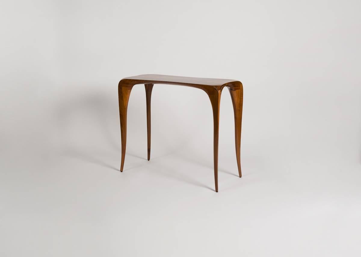 Victor DiNovi's work exhibits a true mastery of craft. In each of his pieces one sees a focus on natural forms rare in the decorative arts. His furniture, inspired by Nouveau, twists and unfurls like the living objects it imitates.

Signed and
