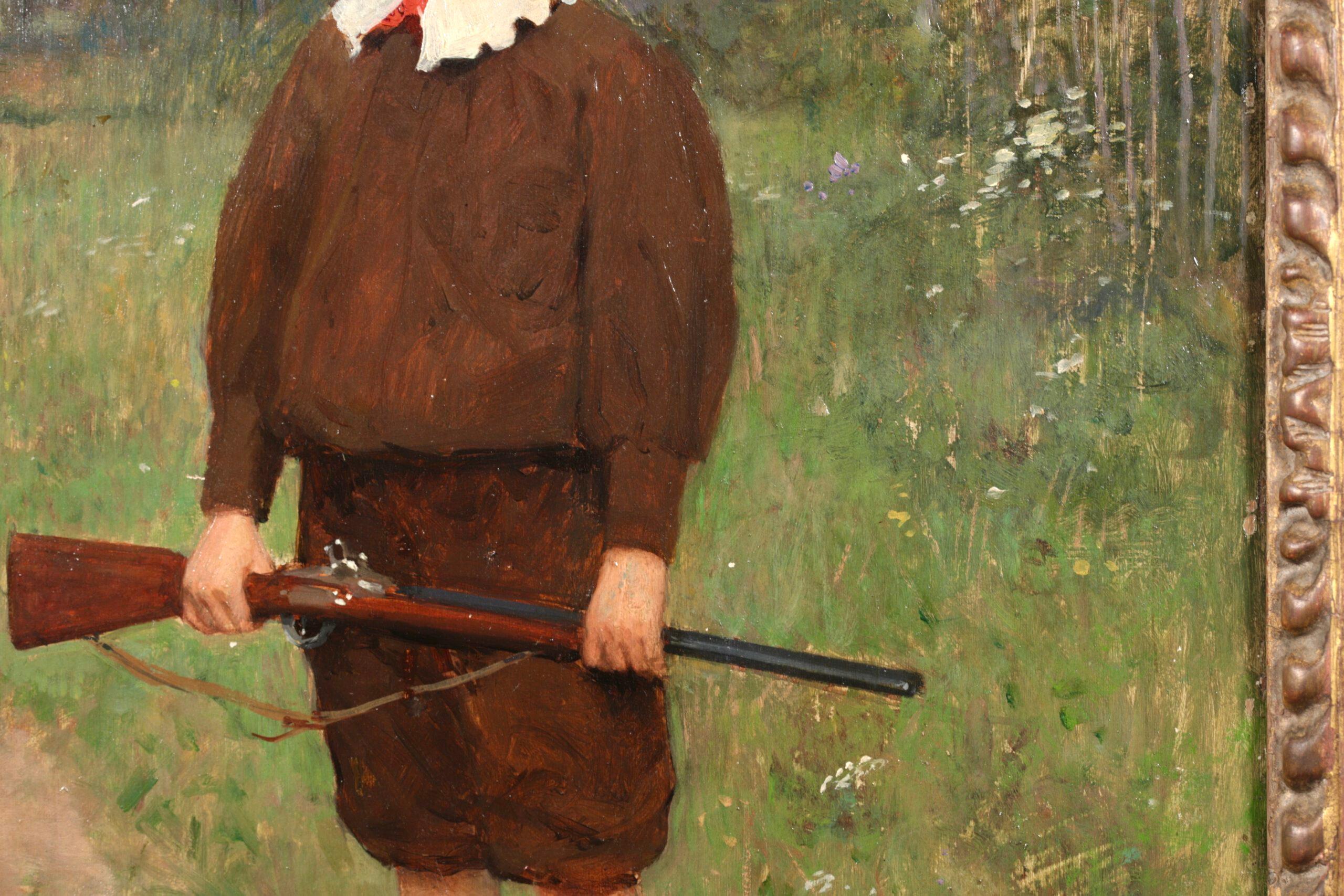 Signiertes Porträt in Öl auf Platte des französischen Realisten Victor Gabriel Gilbert. Das Werk zeigt einen jungen Jäger in brauner Kleidung mit geschnürten Lederstiefeln, der auf einem Weg in einer Landschaft steht und ein Gewehr in der Hand