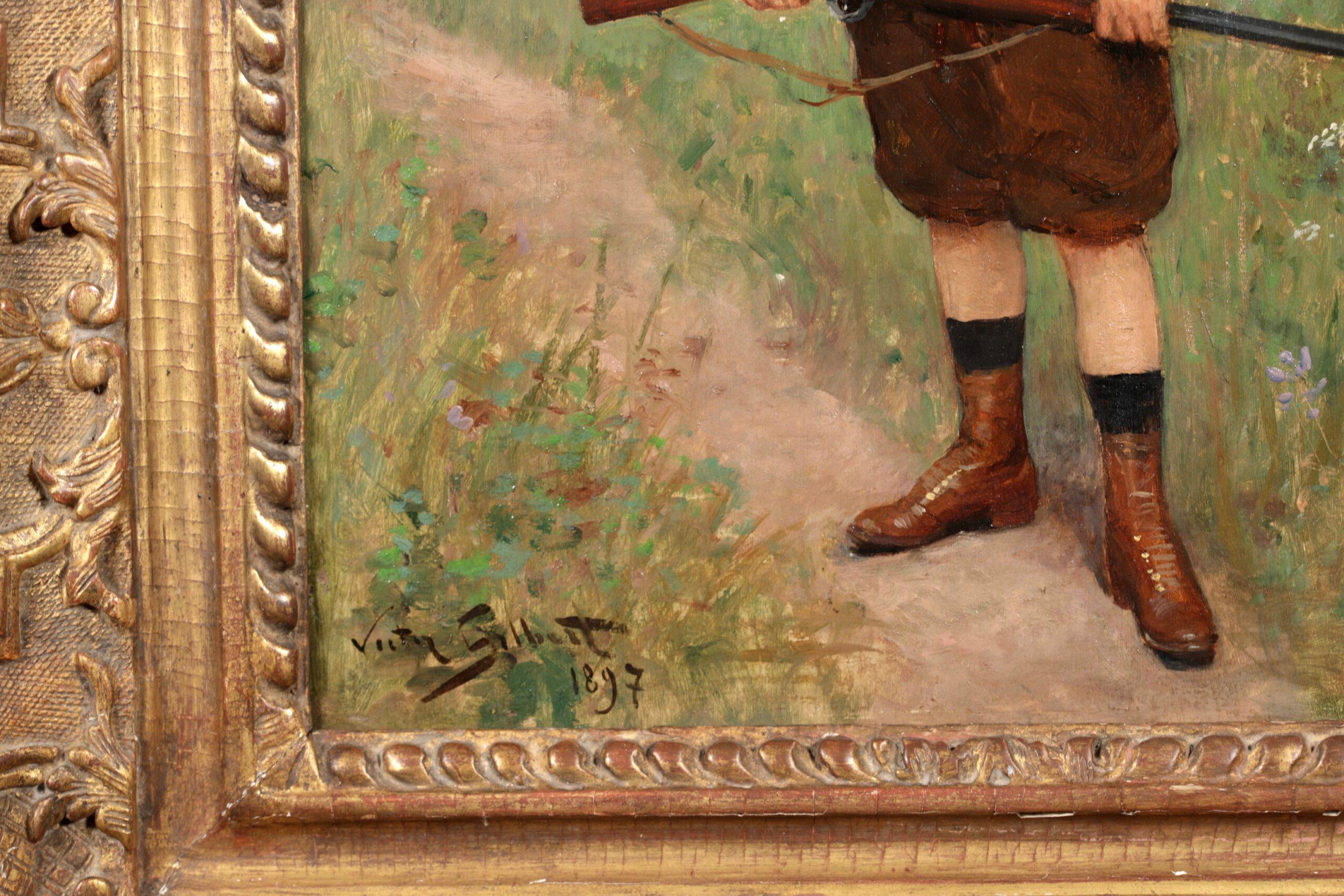 Signed oil on panel portrait by French realist painter Victor Gabriel Gilbert. The work depicts a young hunter wearing a brown outfit with laced up leather boots standing on a path in a landscape holding a shotgun.

Signature:
Signed and dated 1897