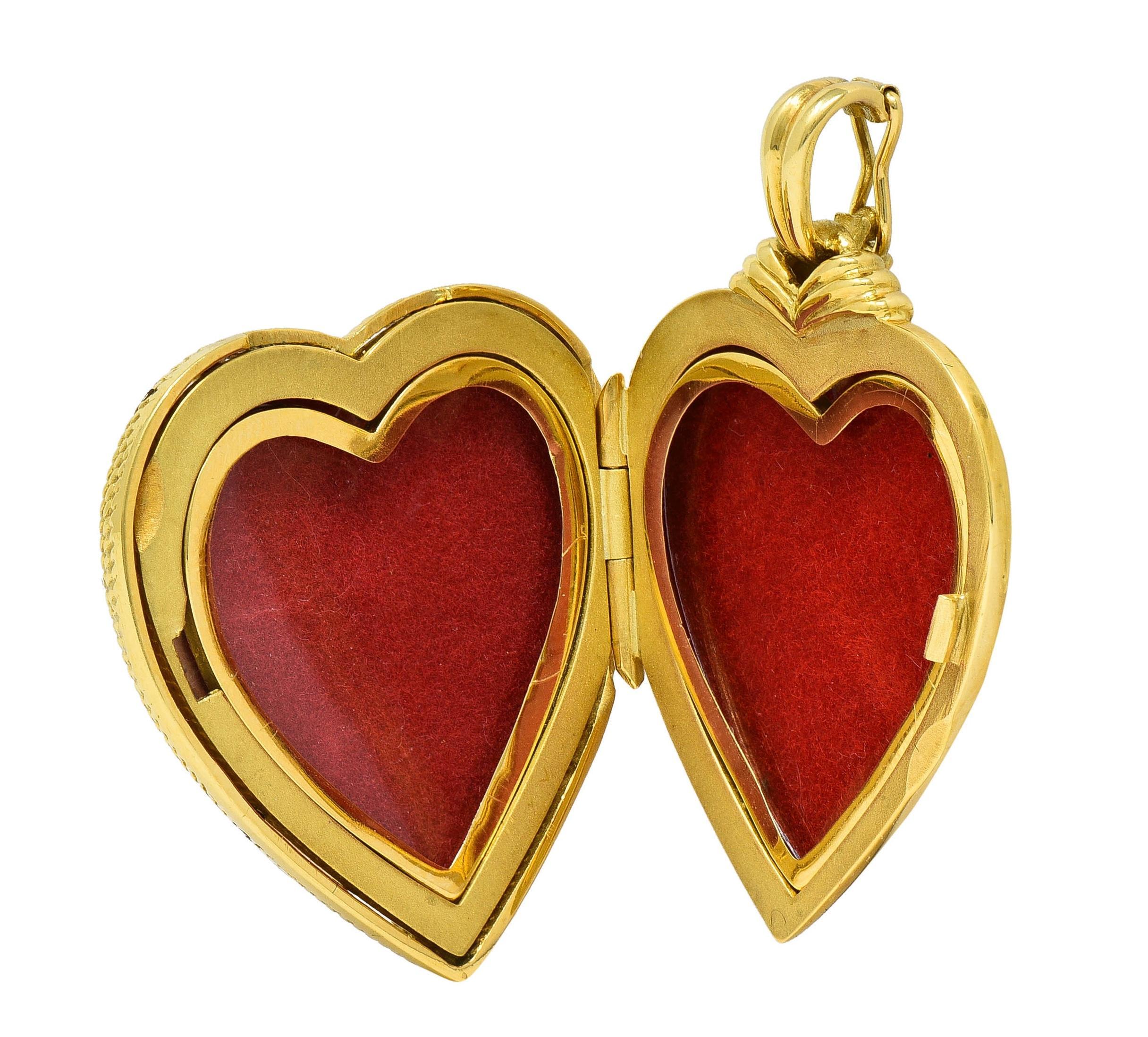 Designed as a heart-shaped locket form suspended from grooved enhancer bale
Featuring a basse-taille style enamel face with orangey pink enamel
Transparent and glossed over an engraved wave pattern
With a gold, net-like twisted rope motif