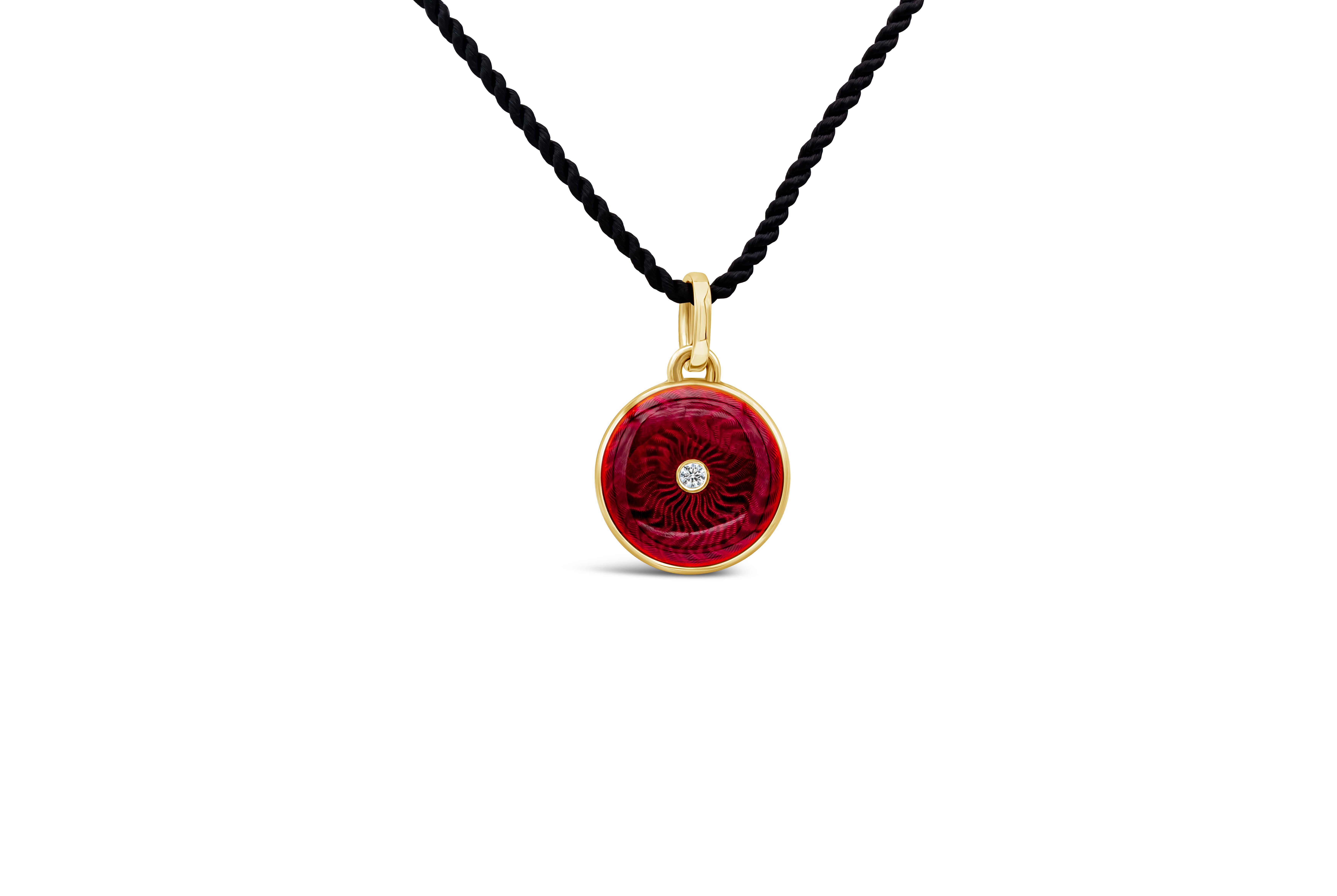 A fashionable circular pendant necklace showcasing a sunburst design red enamel, set with a round brilliant diamond in the middle. Stamped Victor Mayer at the back of the pendant. Made in 18 karat yellow gold. Suspended on a 16 inch yellow gold