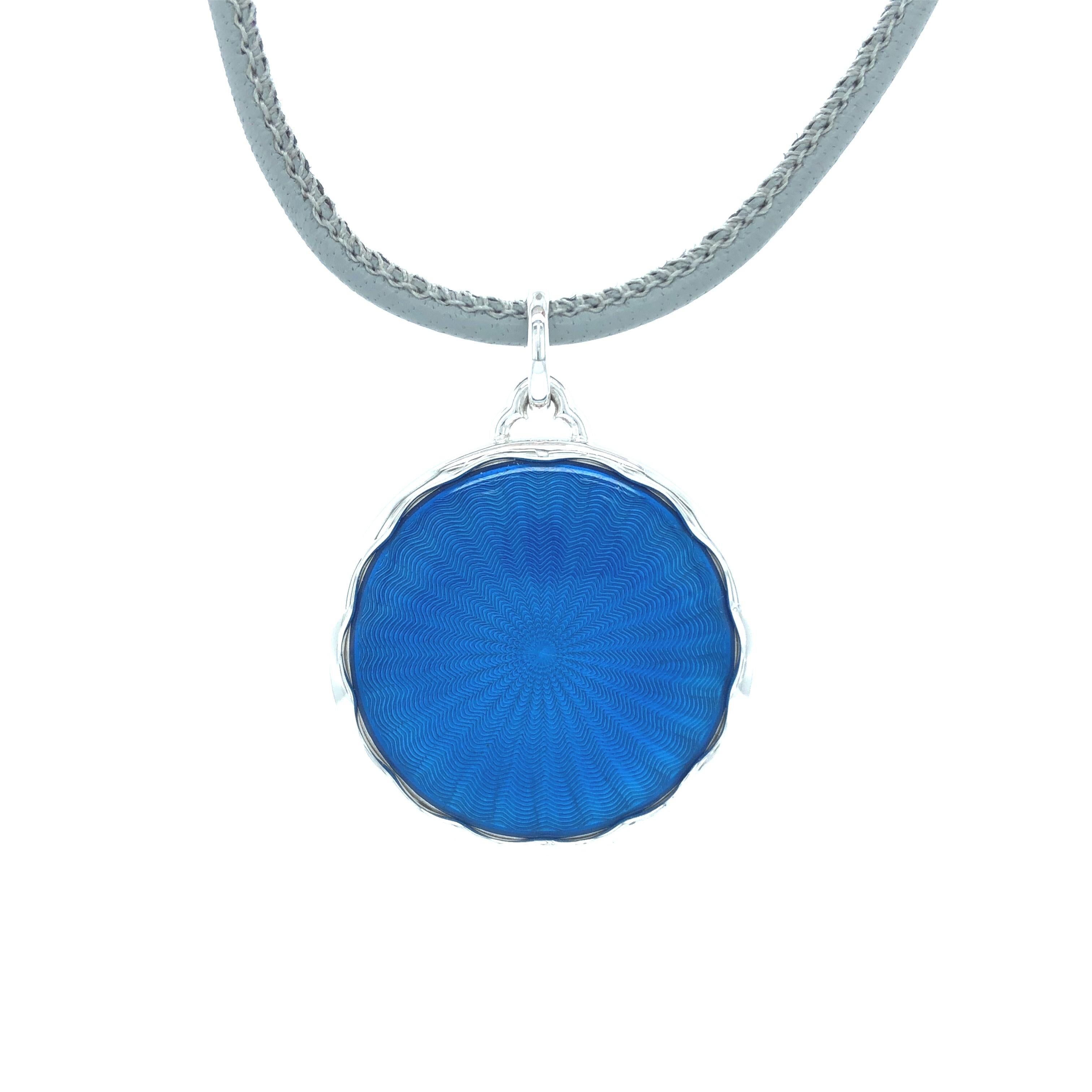 Victor Mayer round pendant collier 18k white gold/925-sterling silver, Macaron Collection, translucent blue vitreous enamel, guilloche, grey leather strap, diameter app. 27.2 mm

About the creator Victor Mayer
Victor Mayer is internationally