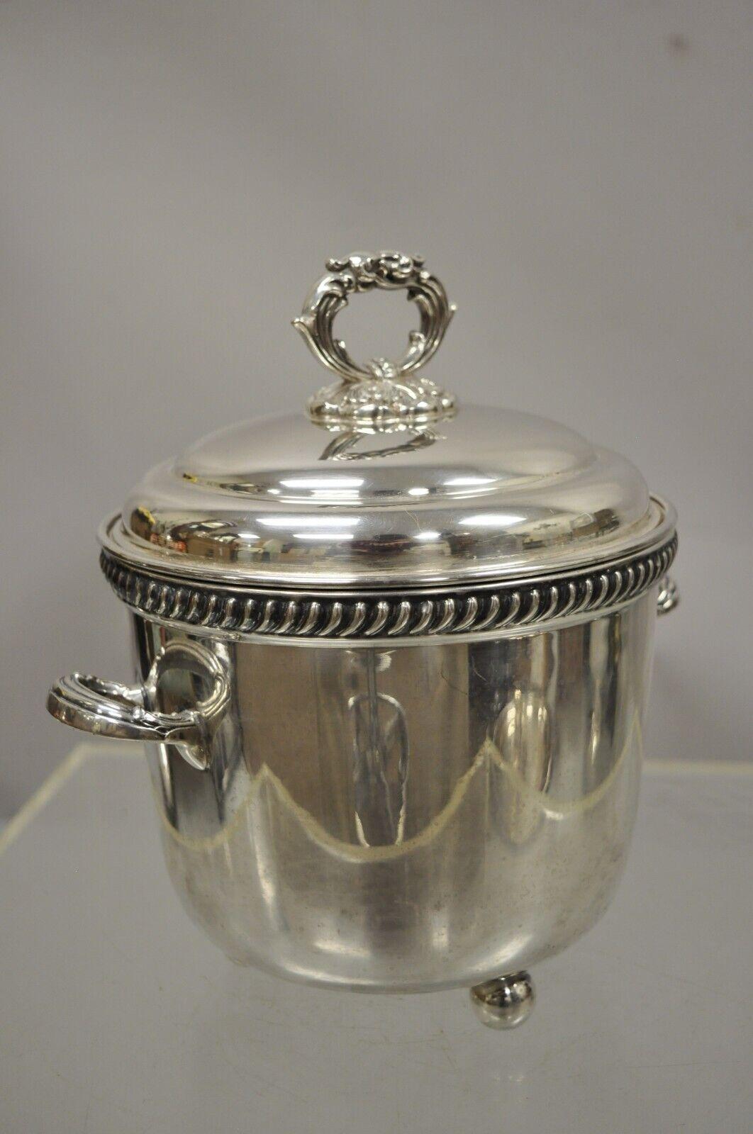 Victor Randolph silver plate lidded ice bucket mercury glass liner ball feet. Item features mercury glass insulated liner, raised on ball form feet, lidded with ornate handle, original stamp. Circa mid 20th century. Measurements: 10
