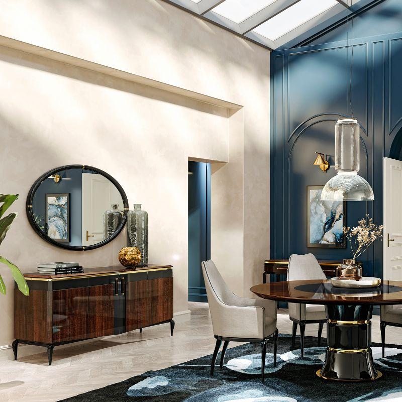 A thoughtful combination of exclusive finishes and dynamic cuts defines the appeal of this round dining table. The bold pedestal support couples glossy black and golden hues, a luxe feel further emphasized by the stately round top sitting atop,