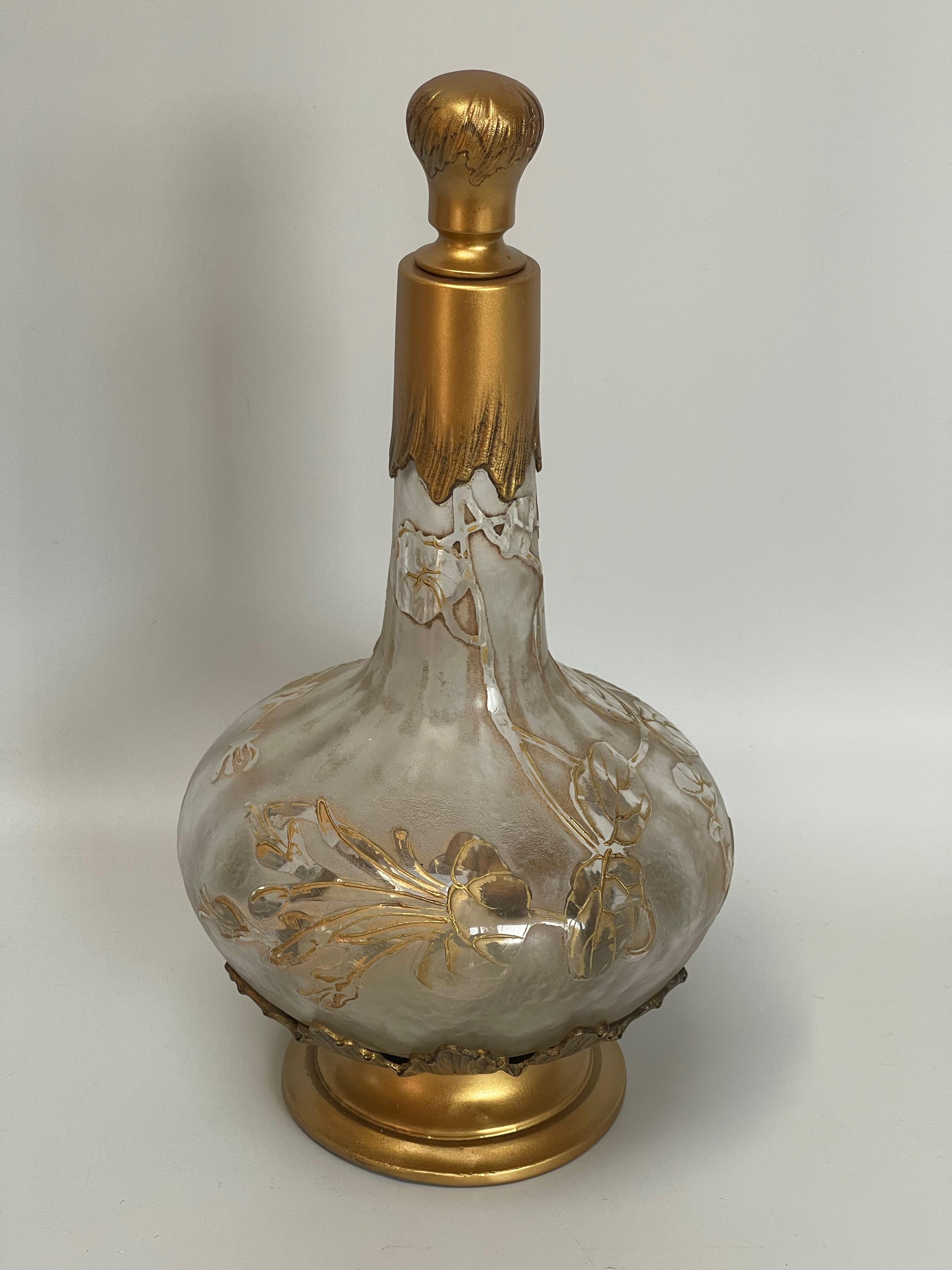 Decanter engraved with acid with floral decoration around 1900 attributed to Daum Nancy and Victor Saglier for the setting. Signature at the bottom of the carafe. Note a slight deformation on the foot.

Measures: Diameter: foot 8.7 cm
Height:
