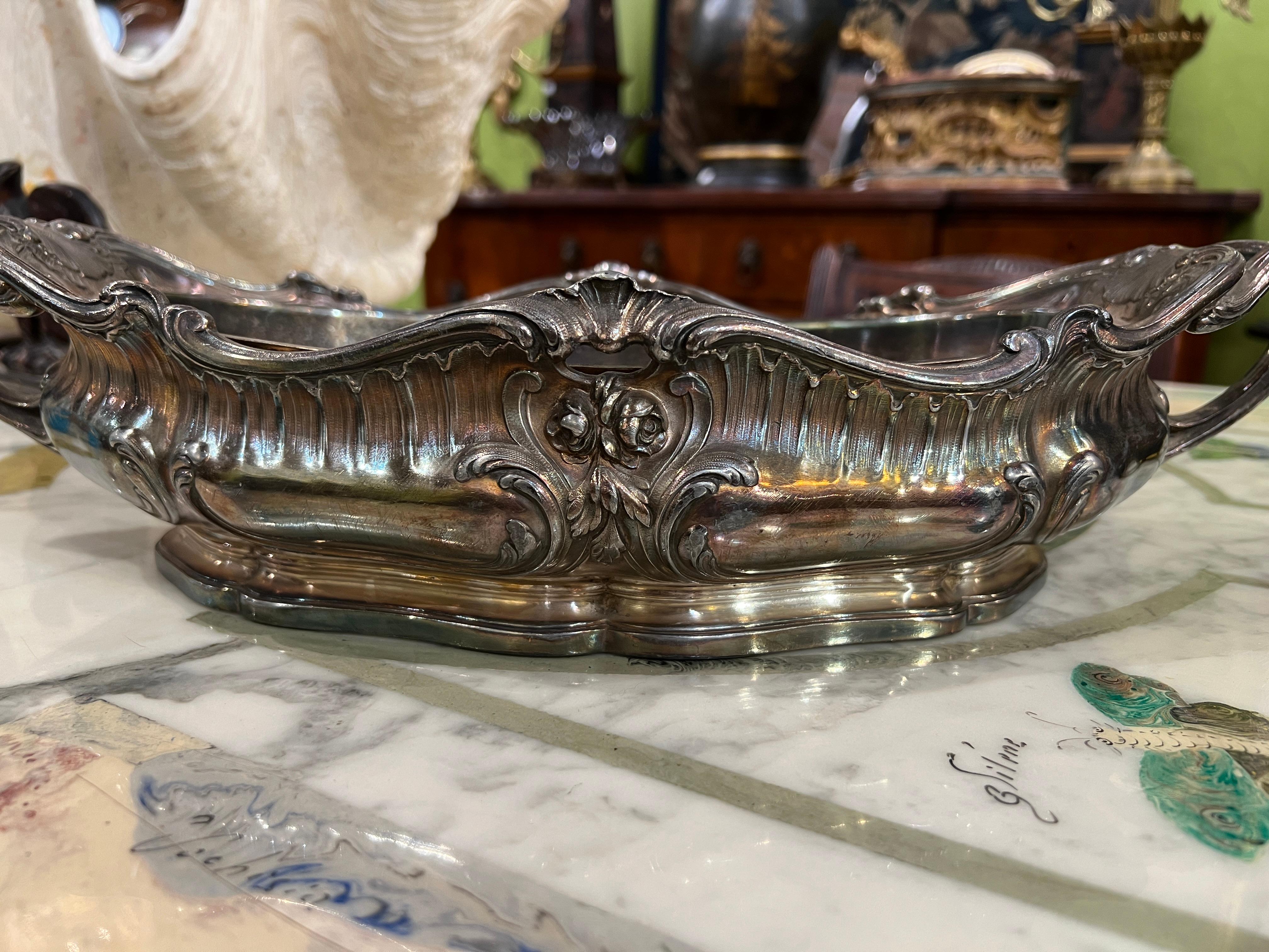 This exquisite silvered bronze centerpiece or planter, attributed to renowned French metalworker Victor Saglier, is a testament to 19th-century French decorative art. The centerpiece features elegant Art Nouveau-inspired detailing, with flowing
