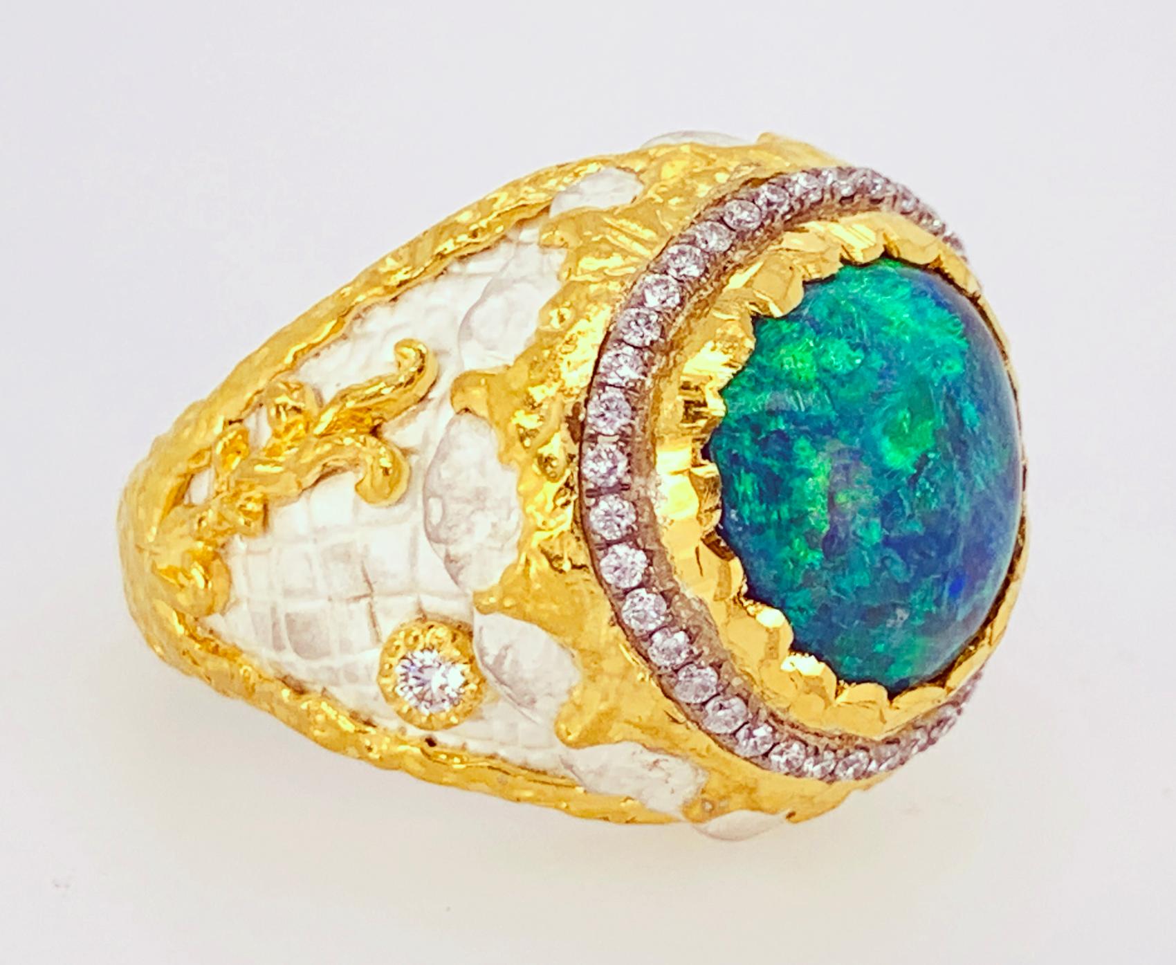 This ring was designed and made by well known designer Victor Velyan.  It features a single Black Opal weighing 5.13 carats is accented by 0.34 carats of fully faceted, round brilliant cut diamonds.  The body of cuff was hand formed in sterling