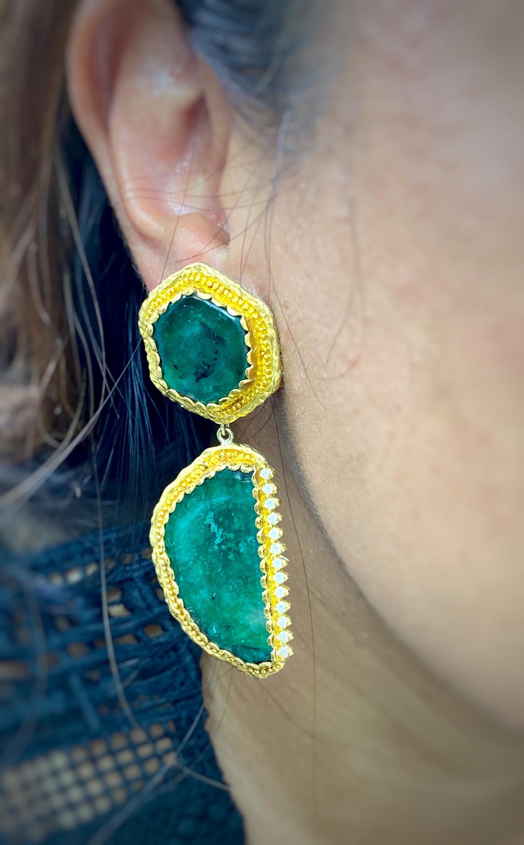 These Earrings were designed and made by well known designer Victor Velyan.   They contain 4 Emerald slices weighing 55.68 carats accented by 0.50 carats in fully faceted Diamond pave.  They are made of a base of pure Silver with all accent work