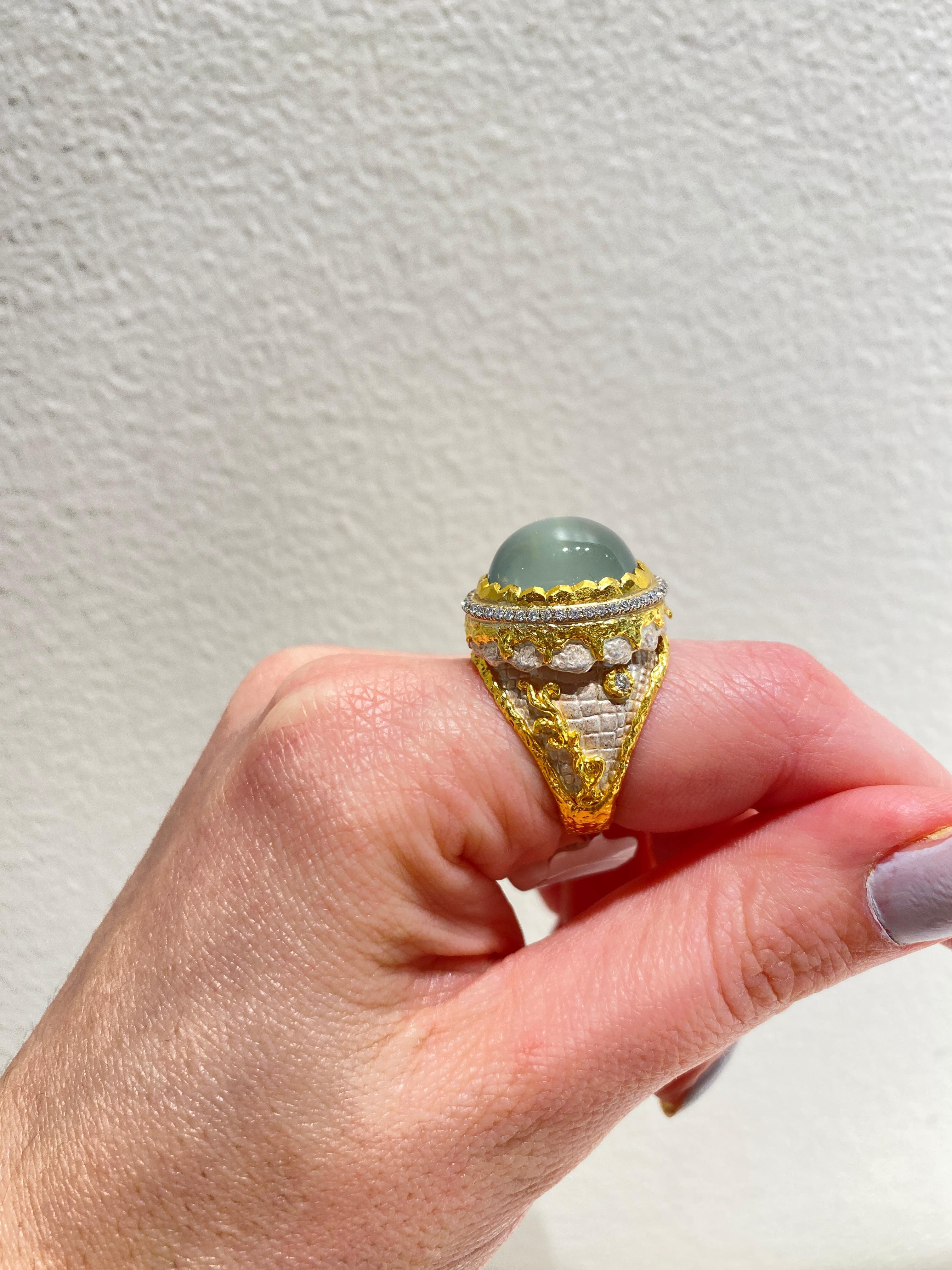 Inspired by the energy pulsating throughout nature, Velyan unites pure metals and gemstones into stunning styles that display the grandeur of fine jewelry.

This ring features a green moonstone with white diamonds set in 24K yellow gold and silver.