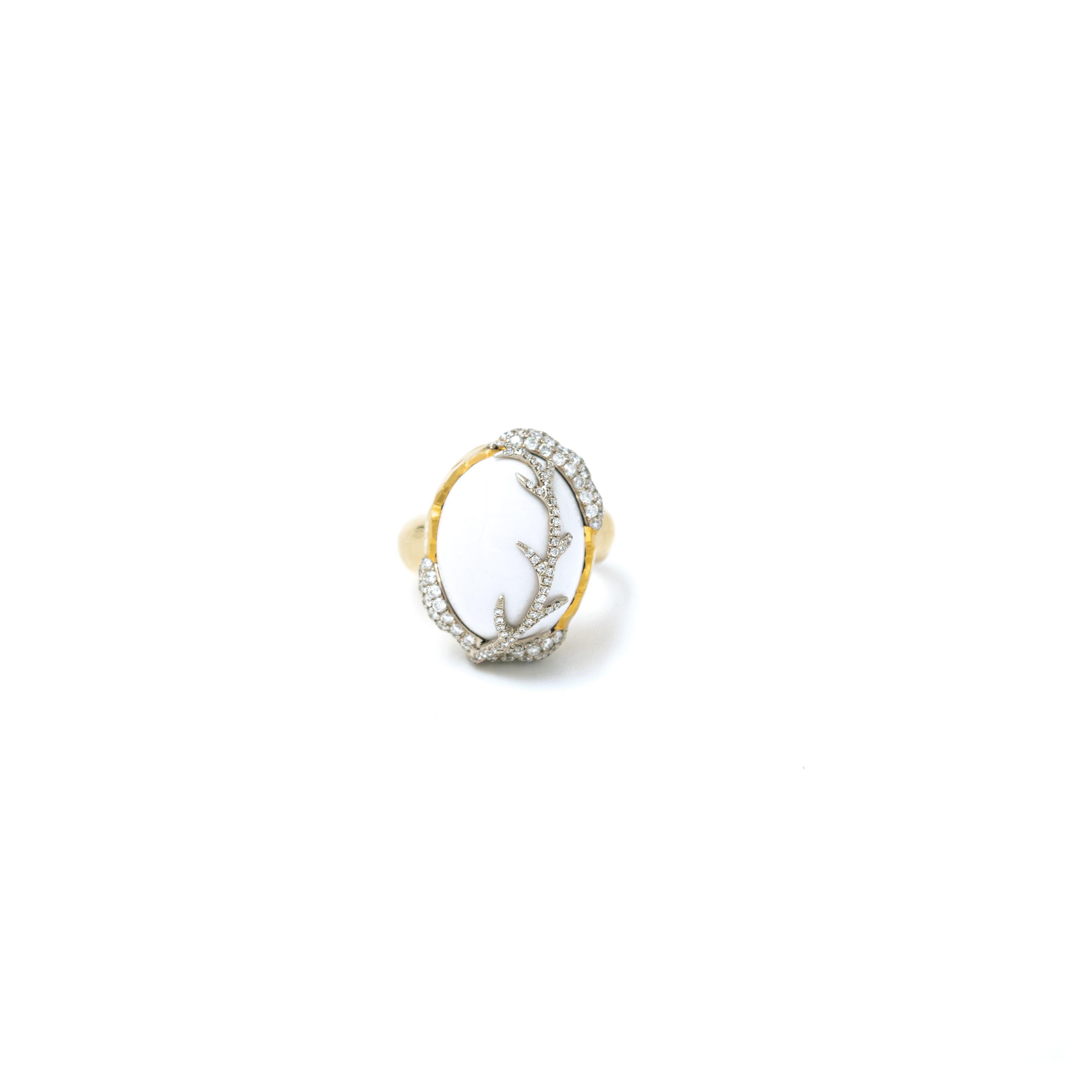 Inspired by the energy pulsating throughout nature, Velyan unites pure metals and gemstones into stunning styles that display the grandeur of fine jewelry.

This ring features white pavé diamonds and a stunning opal set in 18k and 24k yellow