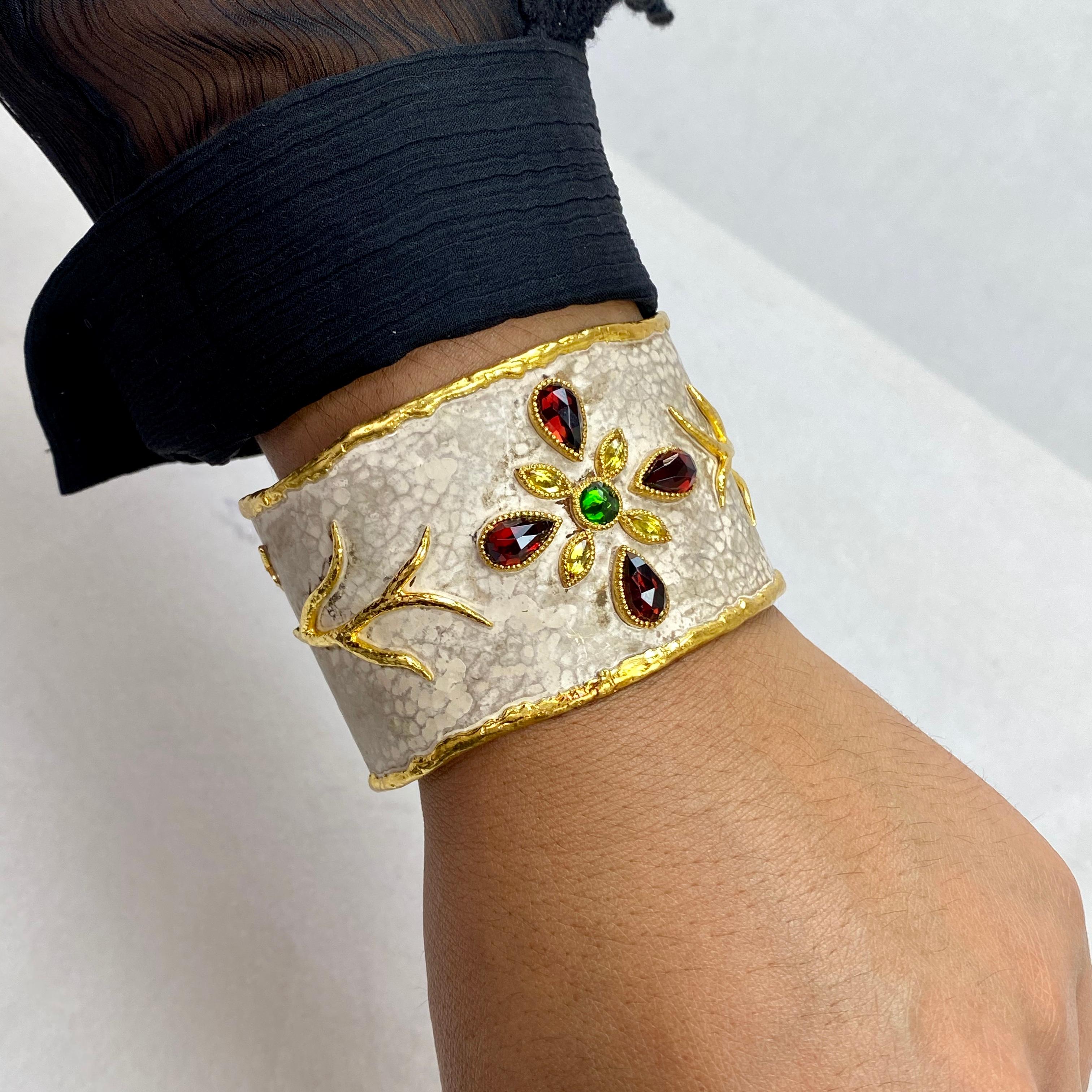 This cuff was designed and made by well known designer Victor Velyan.  It features 4 pear shaped, faceted deep red Garnets weighing 9.17 carats, 4 marquis shaped, faceted Yellow Sapphires weighing 1.19 carats and a single, round brilliant cut Chrome
