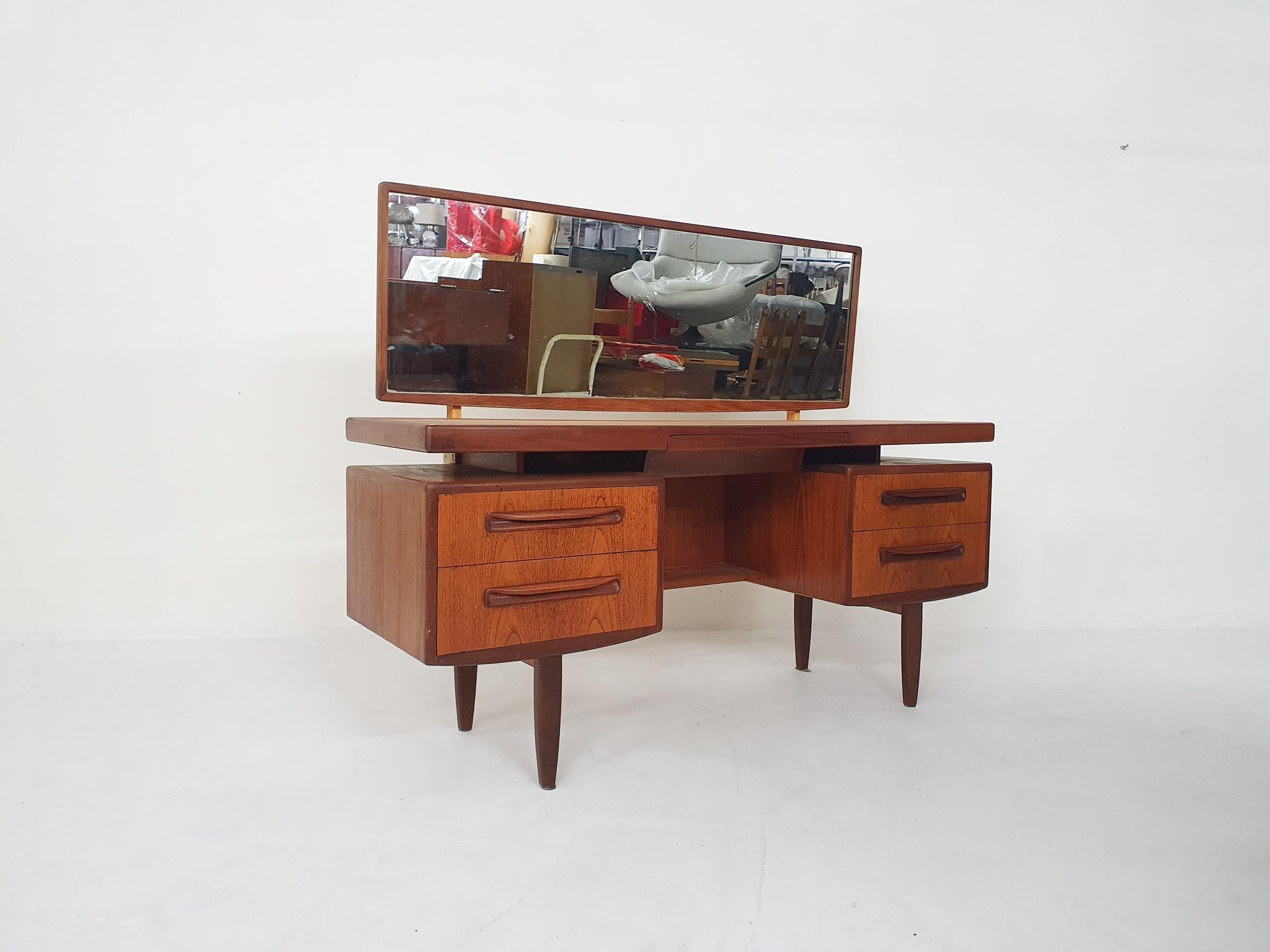 Teak vanity designed by Victor Wilkins for G-plan in the united Kingdom in 1960's
With four drawers and a small drawer in the middle for jewelry. The mirror can swivel up and down.

The attachment of the mirror has been reinforced with some