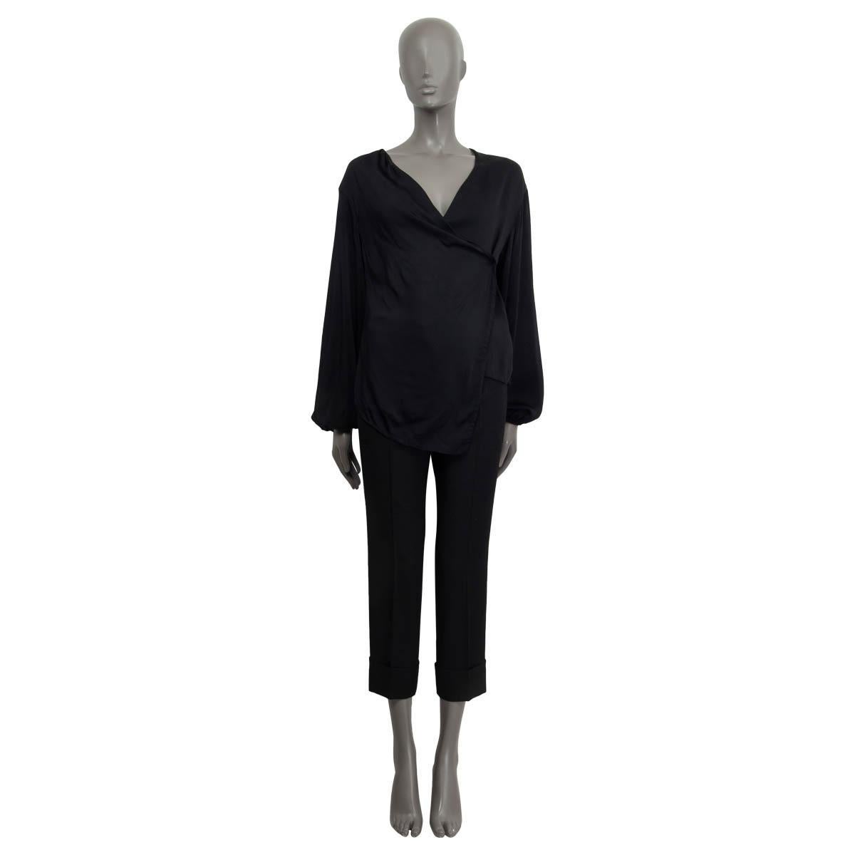 100% authentic Victoria Beckham long sleeve shirt in black polyester (100%). Features a deep v-neck and a diagonal cut. Opens with two concealed buttons on the front. Lined in black silk (100%). Has been worn and is in excellent