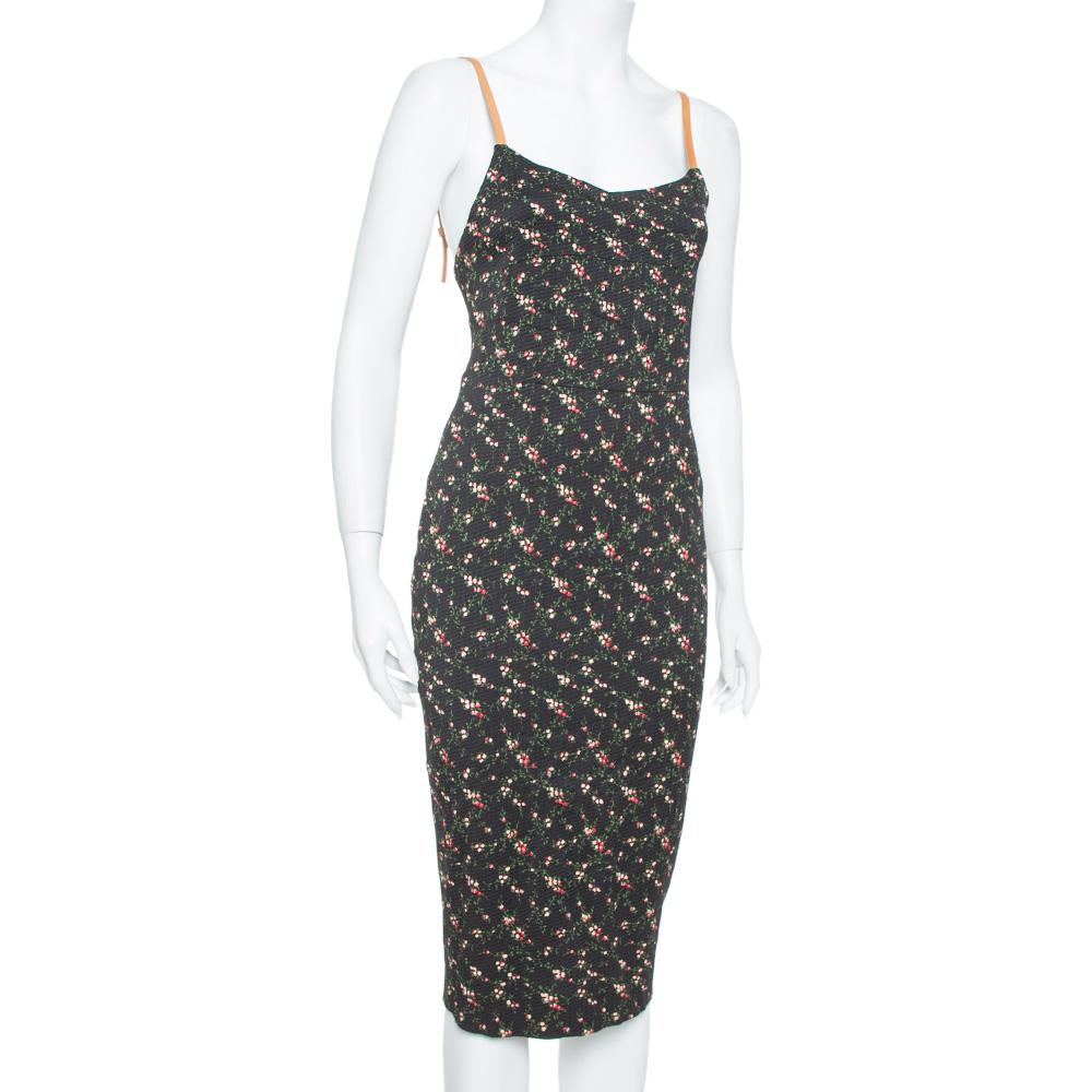 Designs by Victoria Beckham are always a visual delight, and so is this sheath dress. It features a lovely floral print all over the black body along with adjustable leather straps and a body-hugging silhouette. This pretty outfit is an excellent